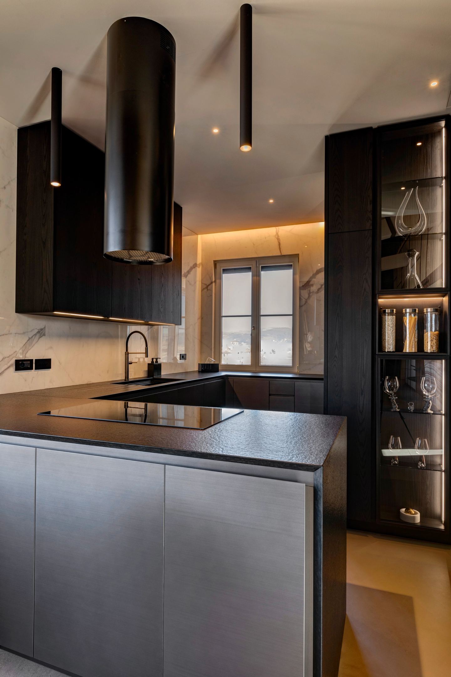 The kitchen island under its black extractor hood