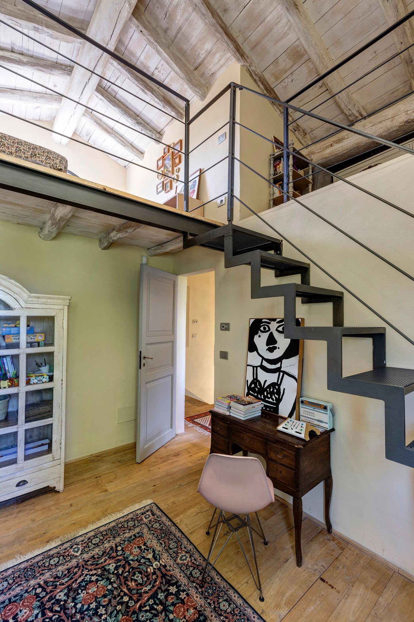 The mezzanine above the room, the stair and the painted wardrobe