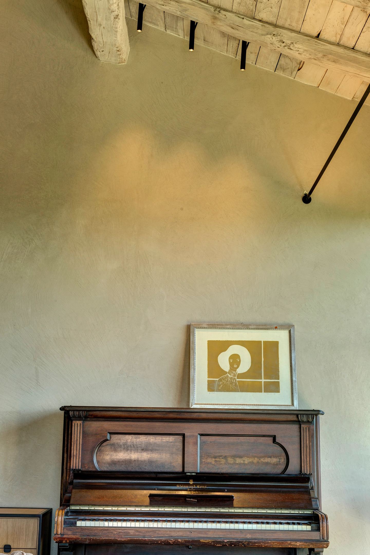 The piano and the drawing hung above it