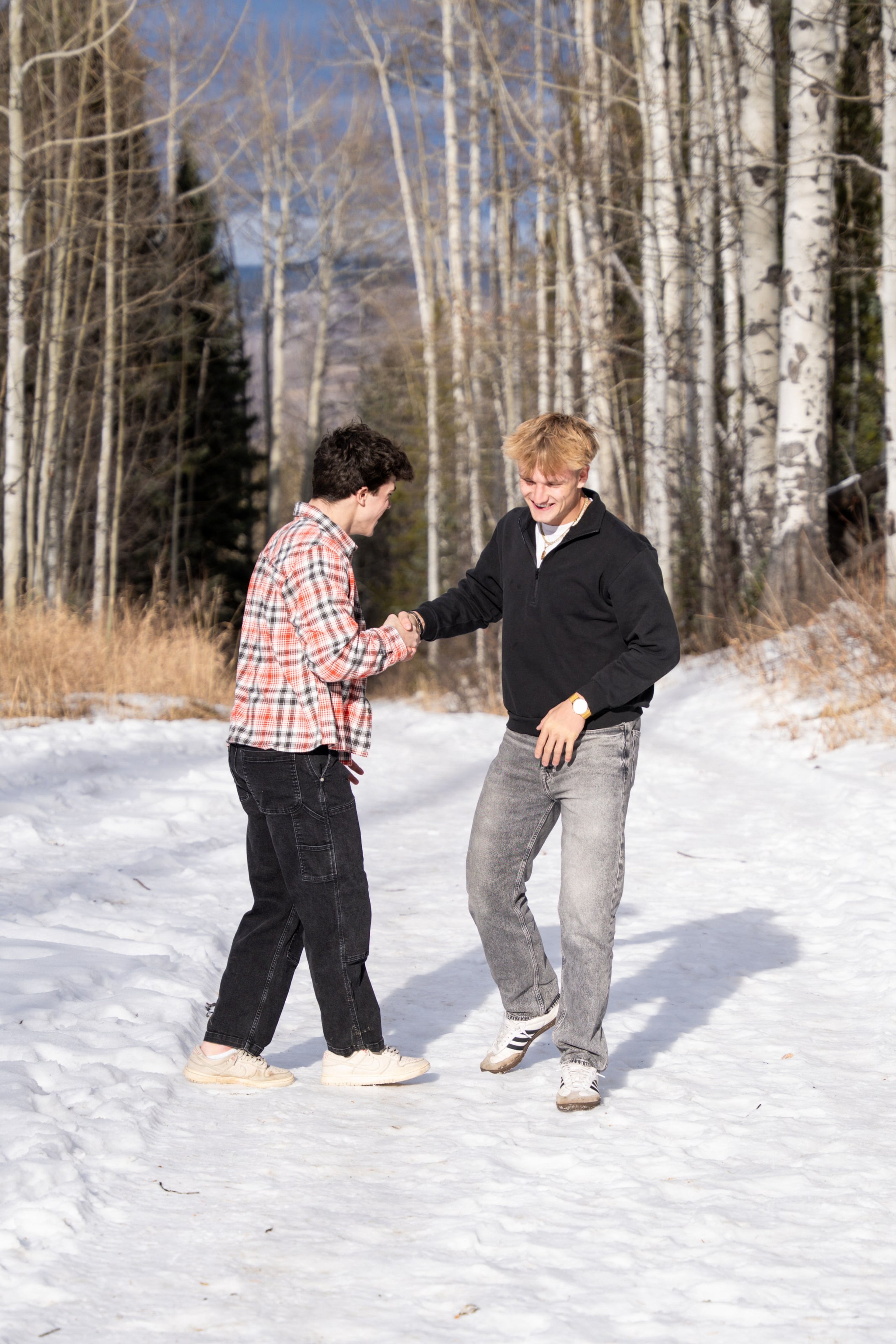 Jakob and Ryder mid-handshake on the winter trail