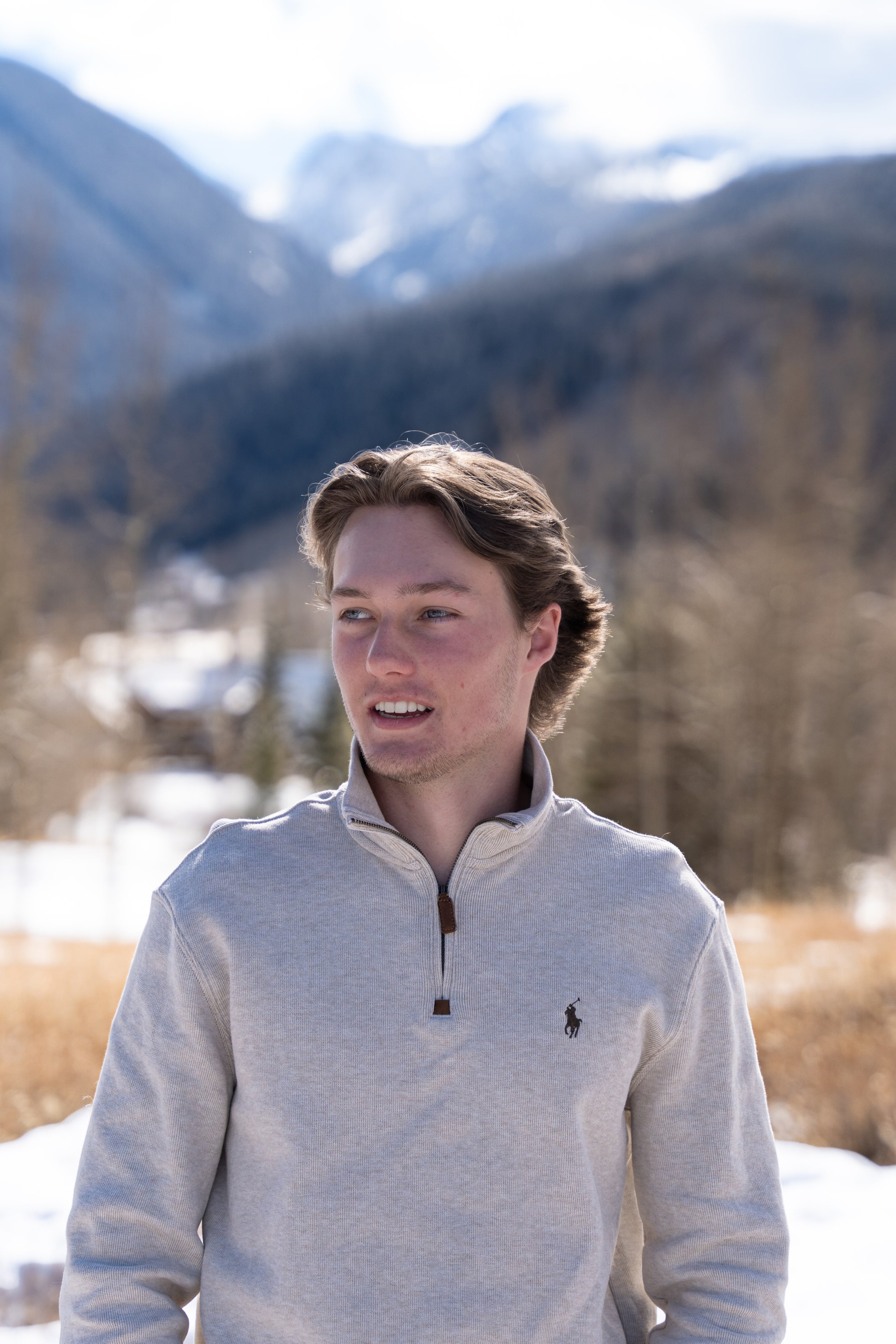 Caeden mid-laugh in the winter meadow