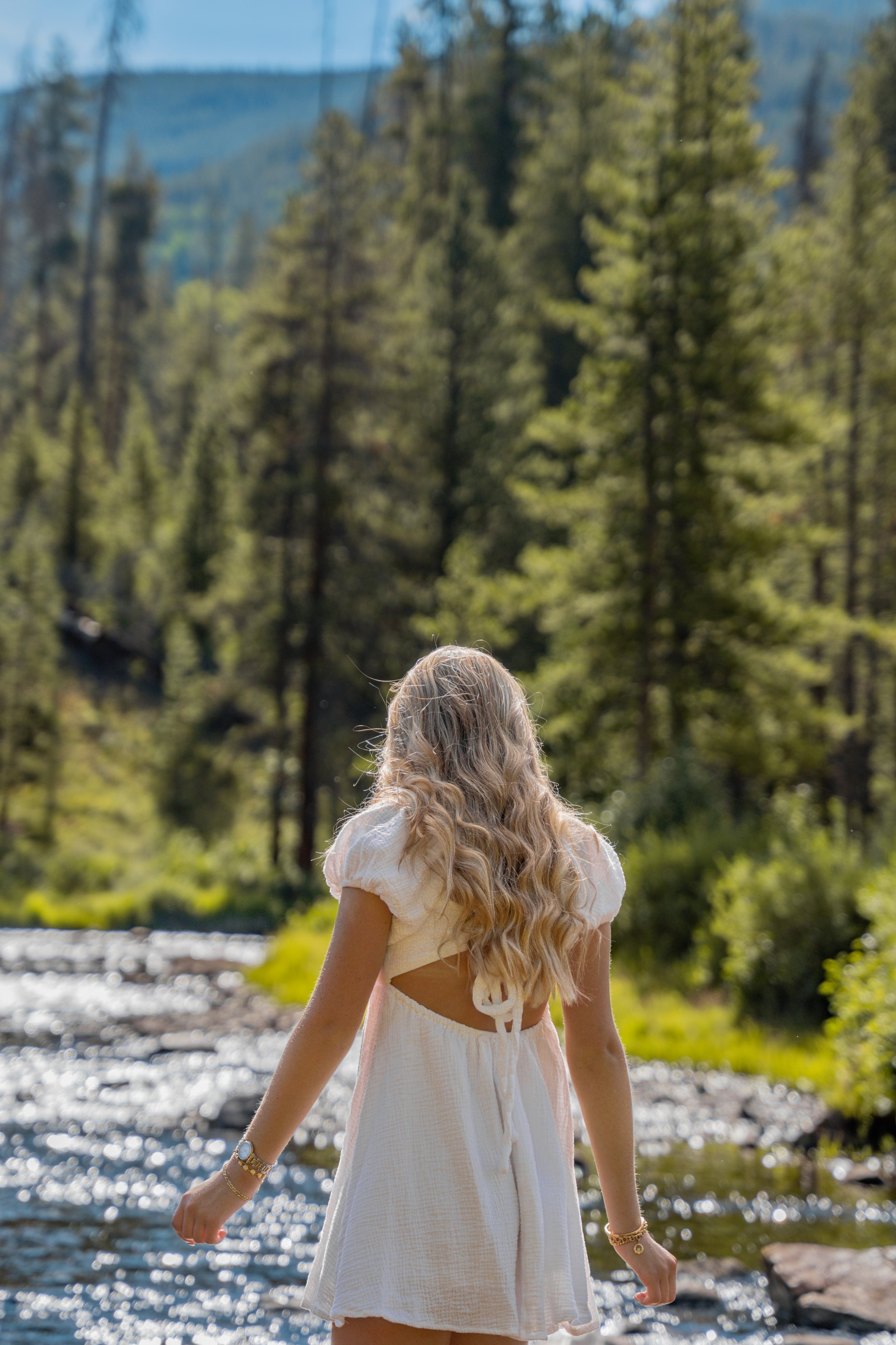Caleigh facing the river with sunlight catching her hair