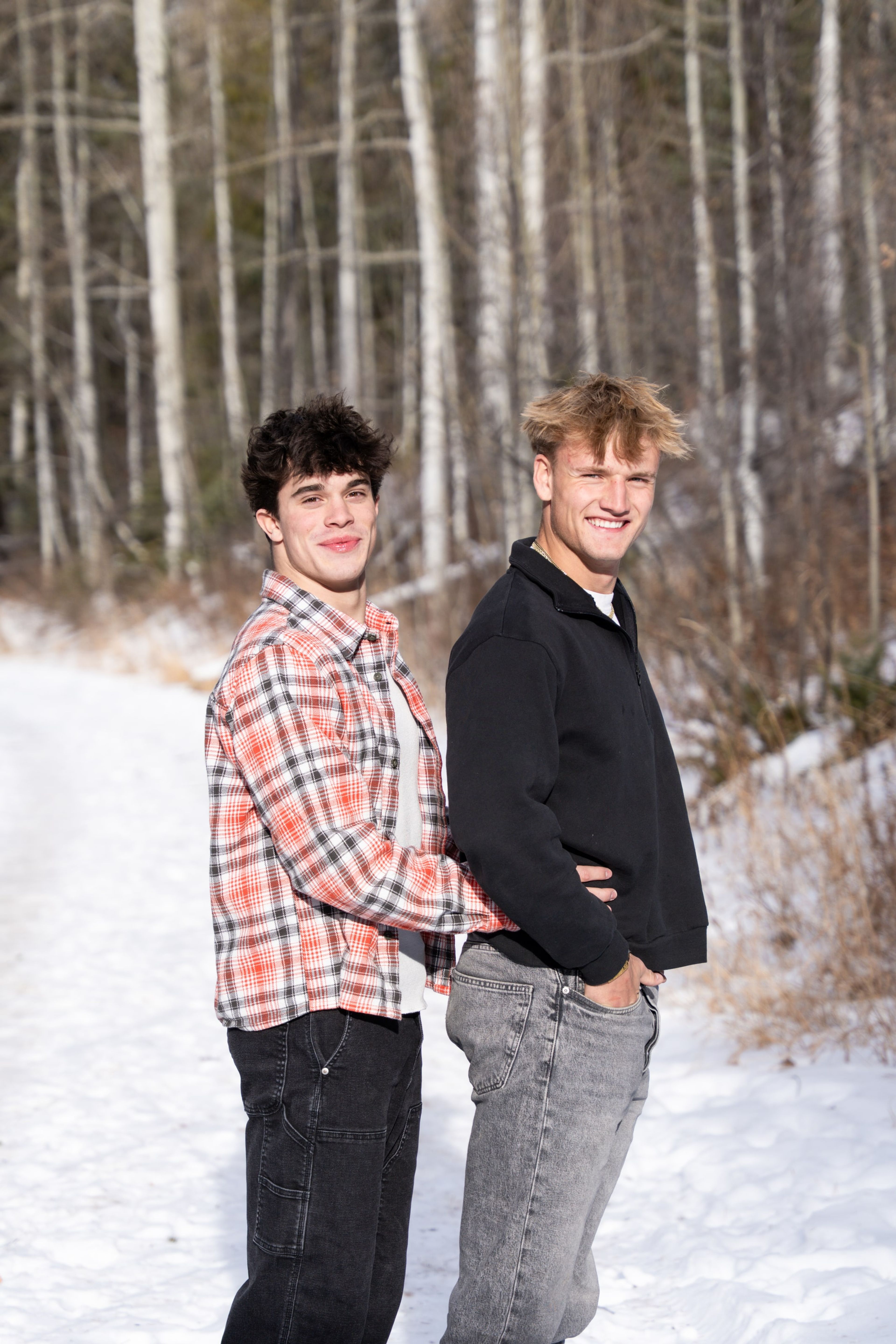 Jakob and Ryder back to back, grinning in the aspens
