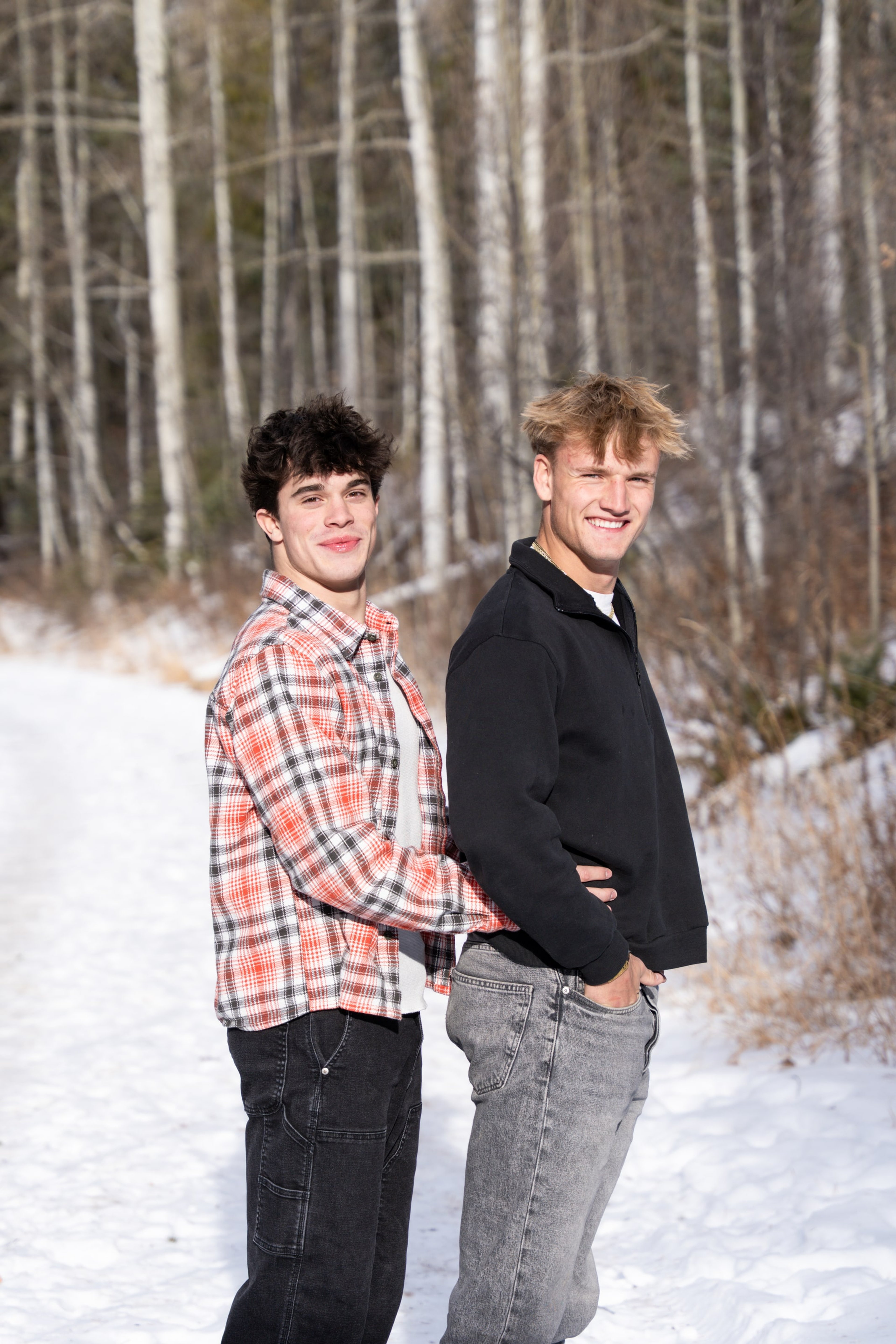 Jakob and Ryder back to back, grinning in the aspens