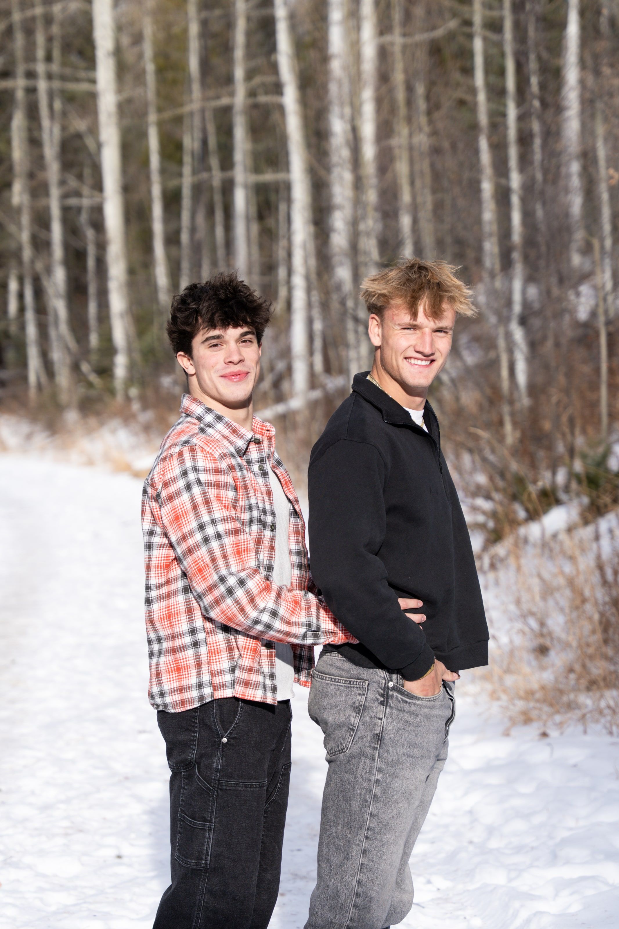 Jakob and Ryder back to back, grinning in the aspens
