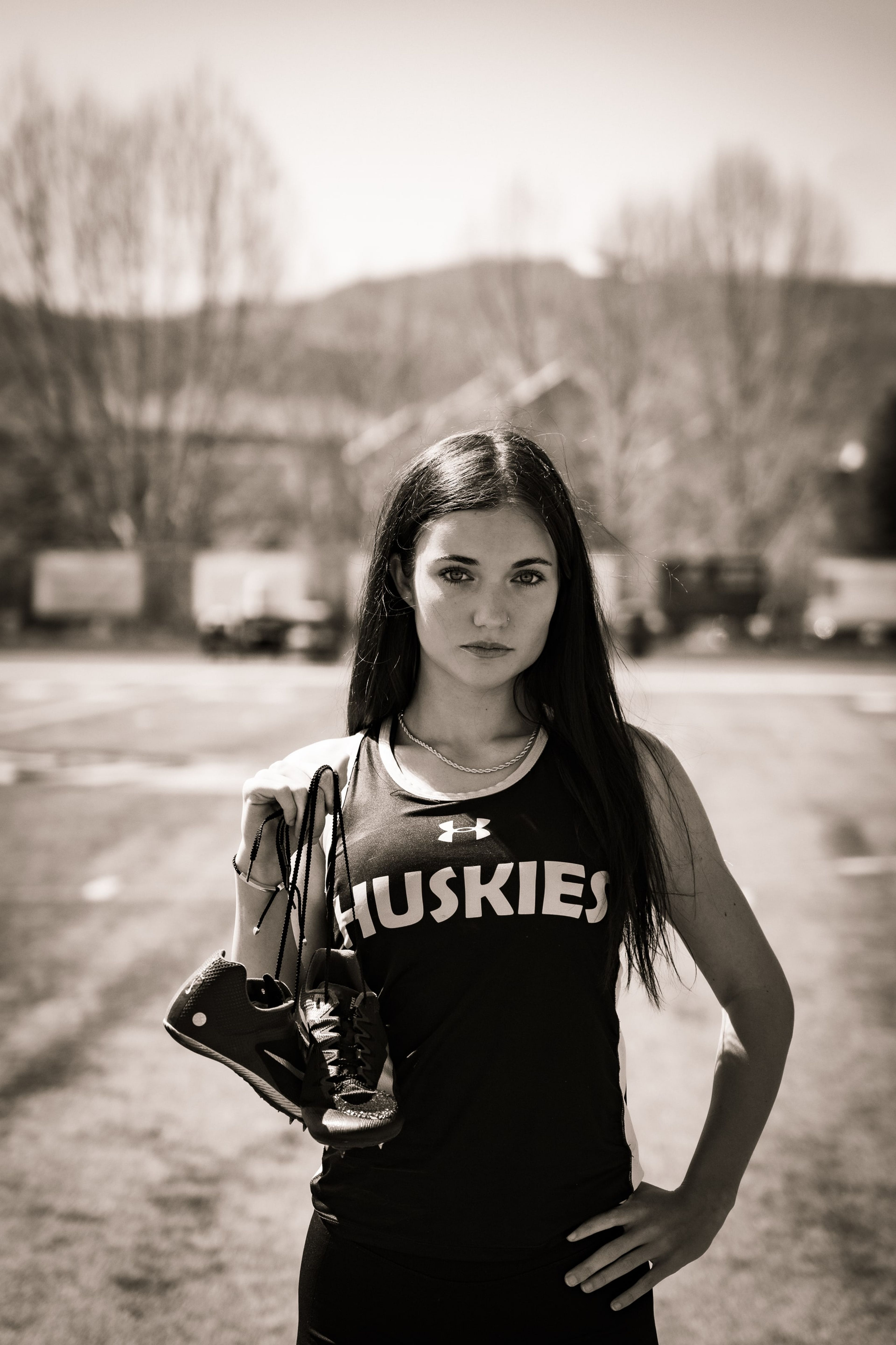 Lucy holding her spikes in warm sepia field light
