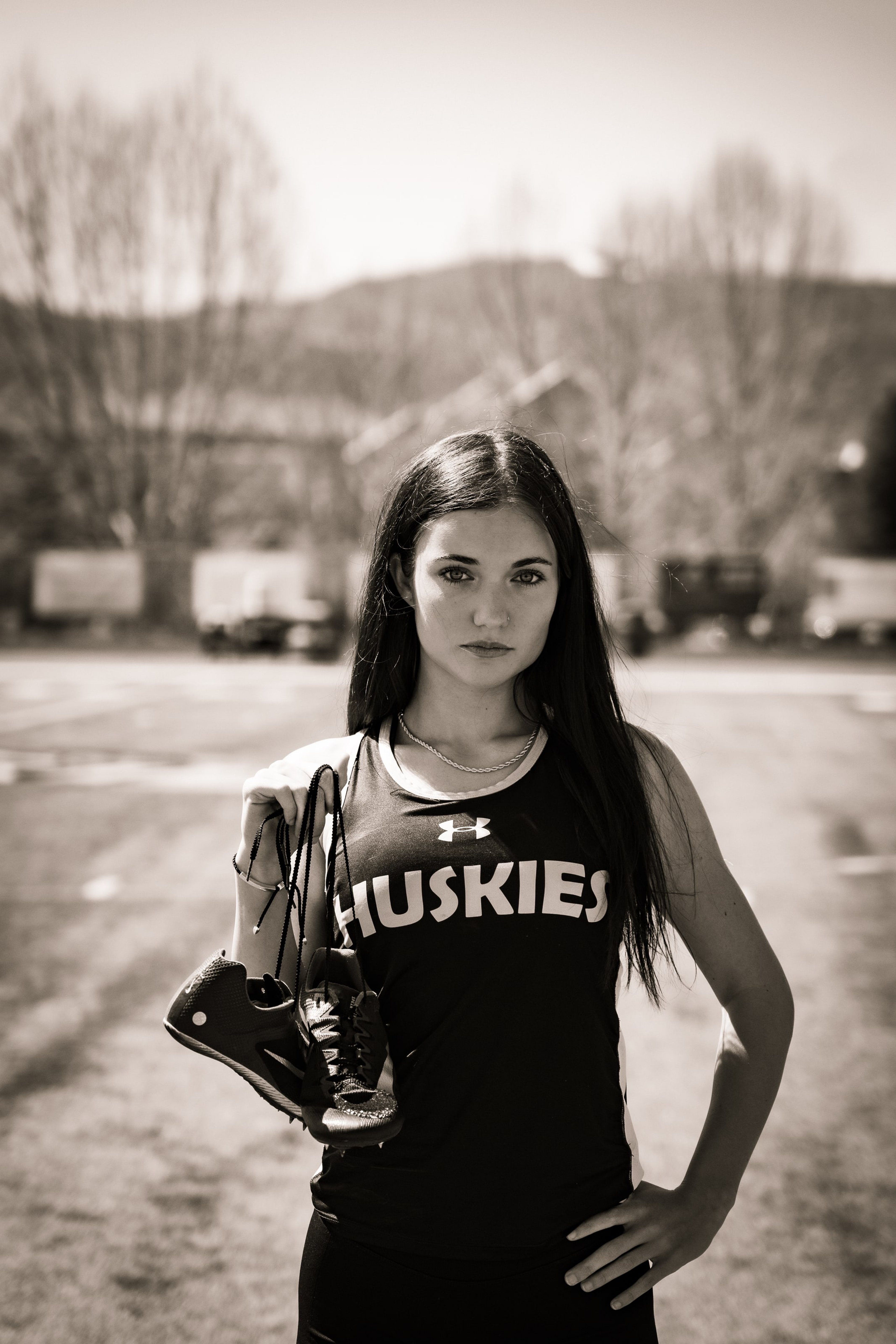 Lucy holding her spikes in warm sepia field light