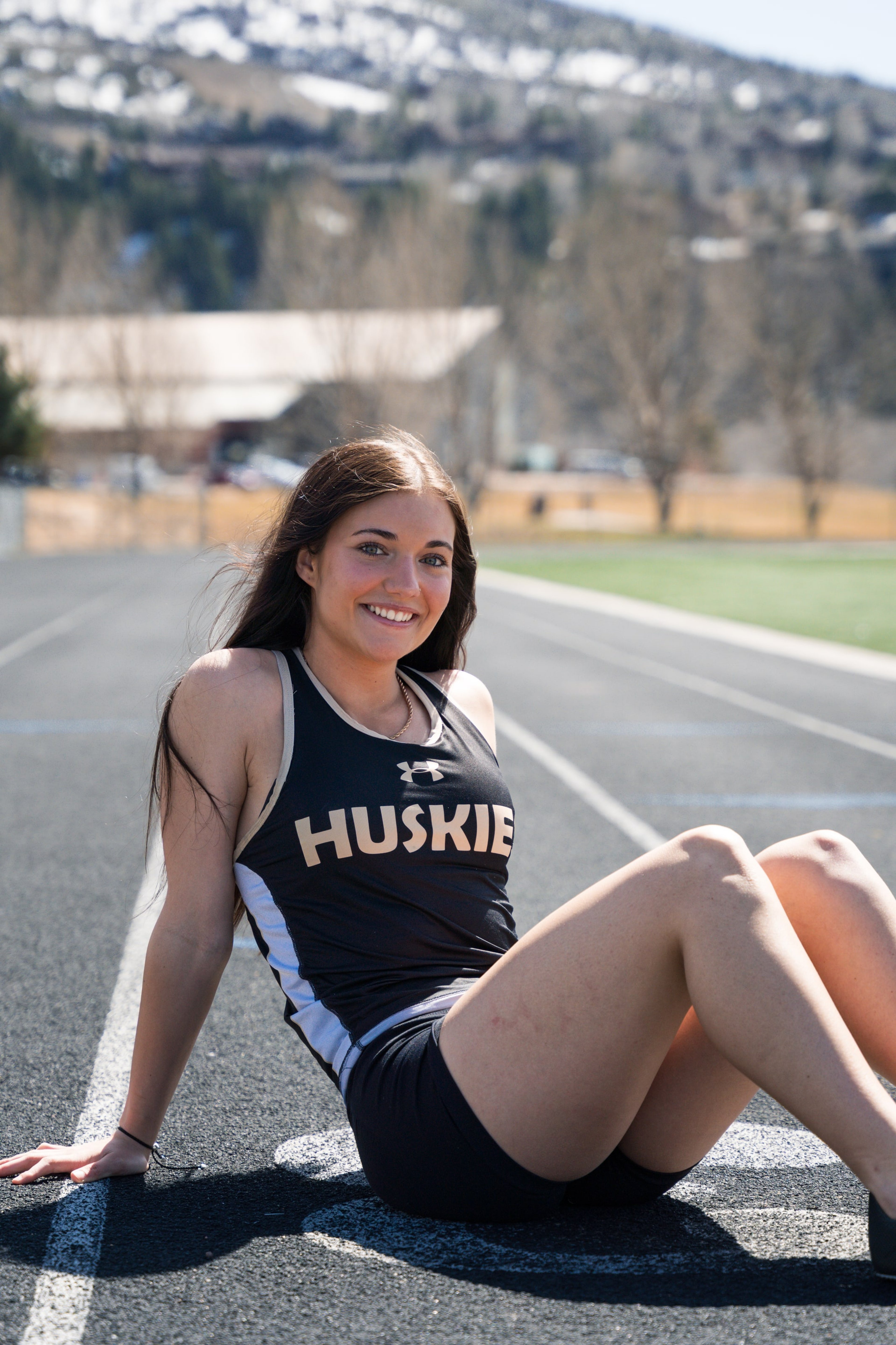 Lucy seated on the lanes smiling straight into the lens