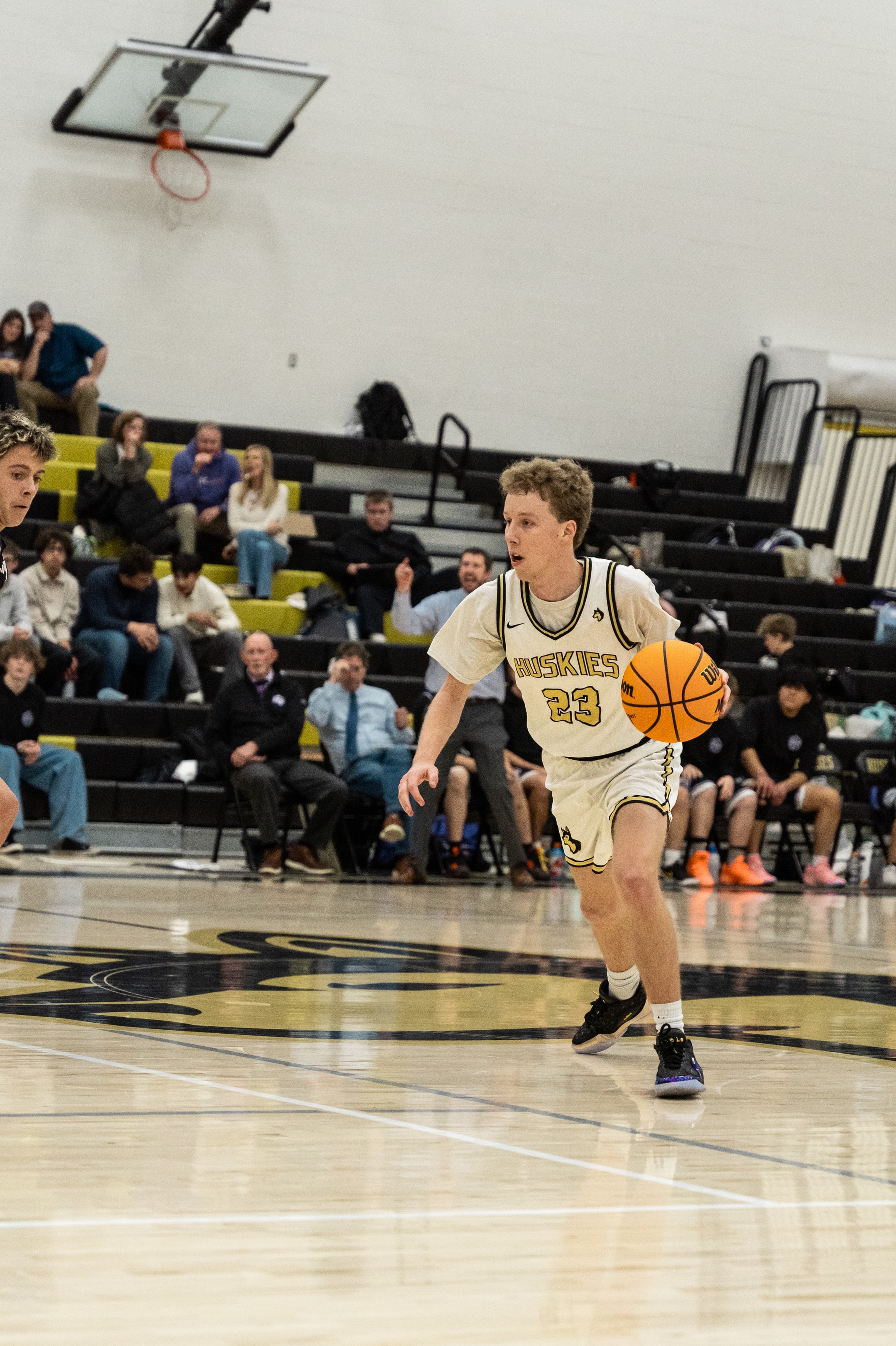 A Huskies player brings the ball up the court