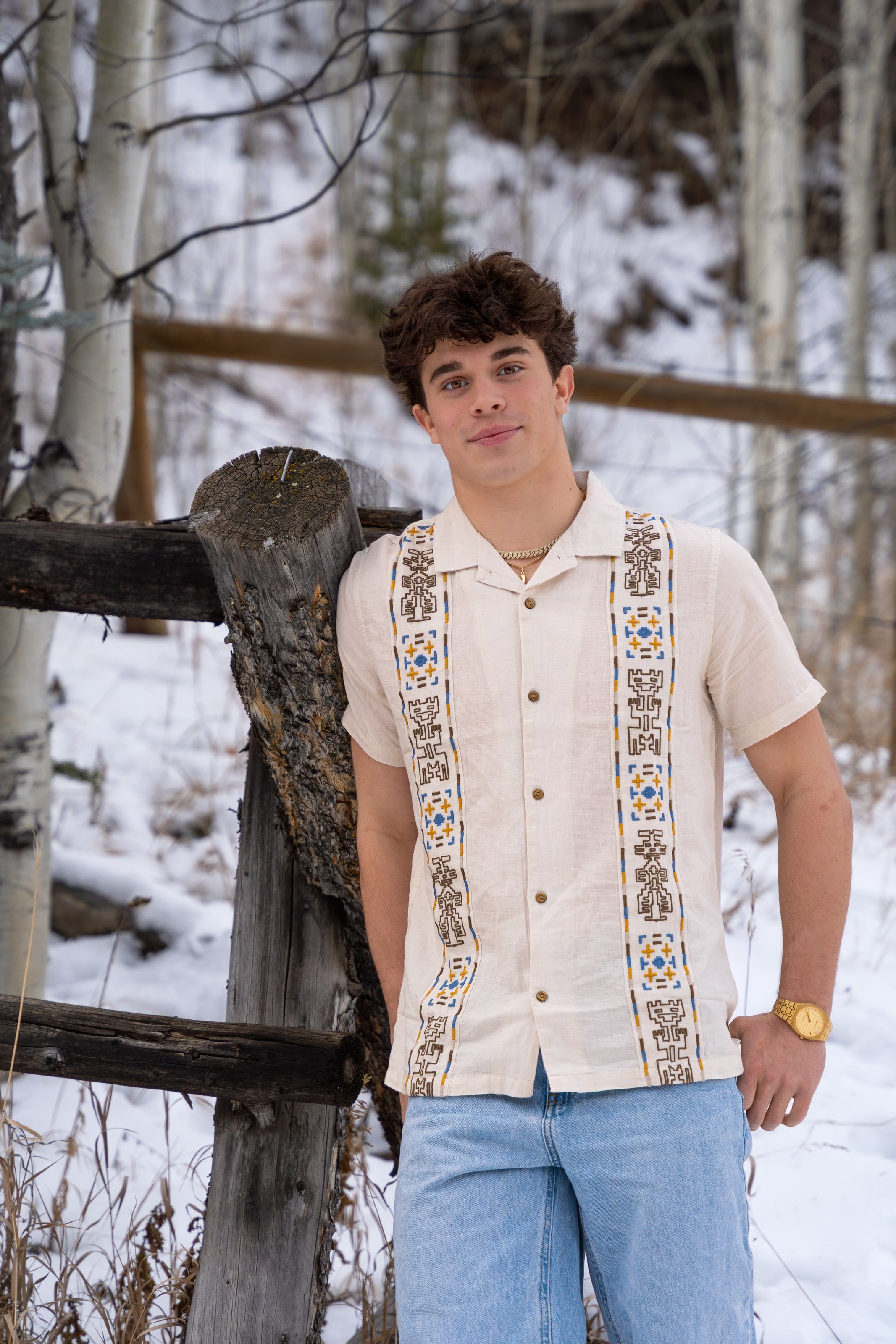 Ryder leaning on a fence post in a patterned shirt