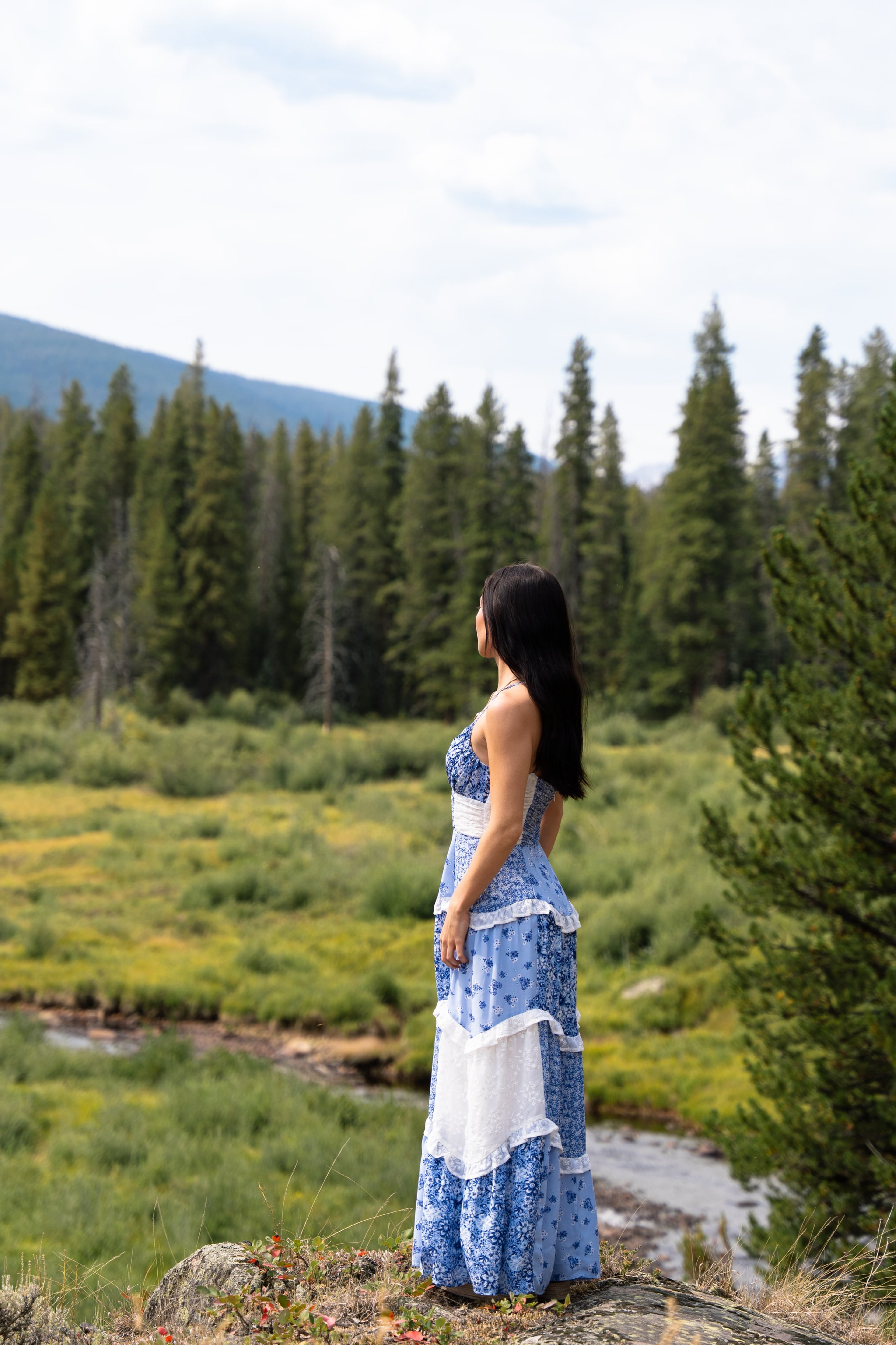 Lucy in a blue dress on the forest creek bank