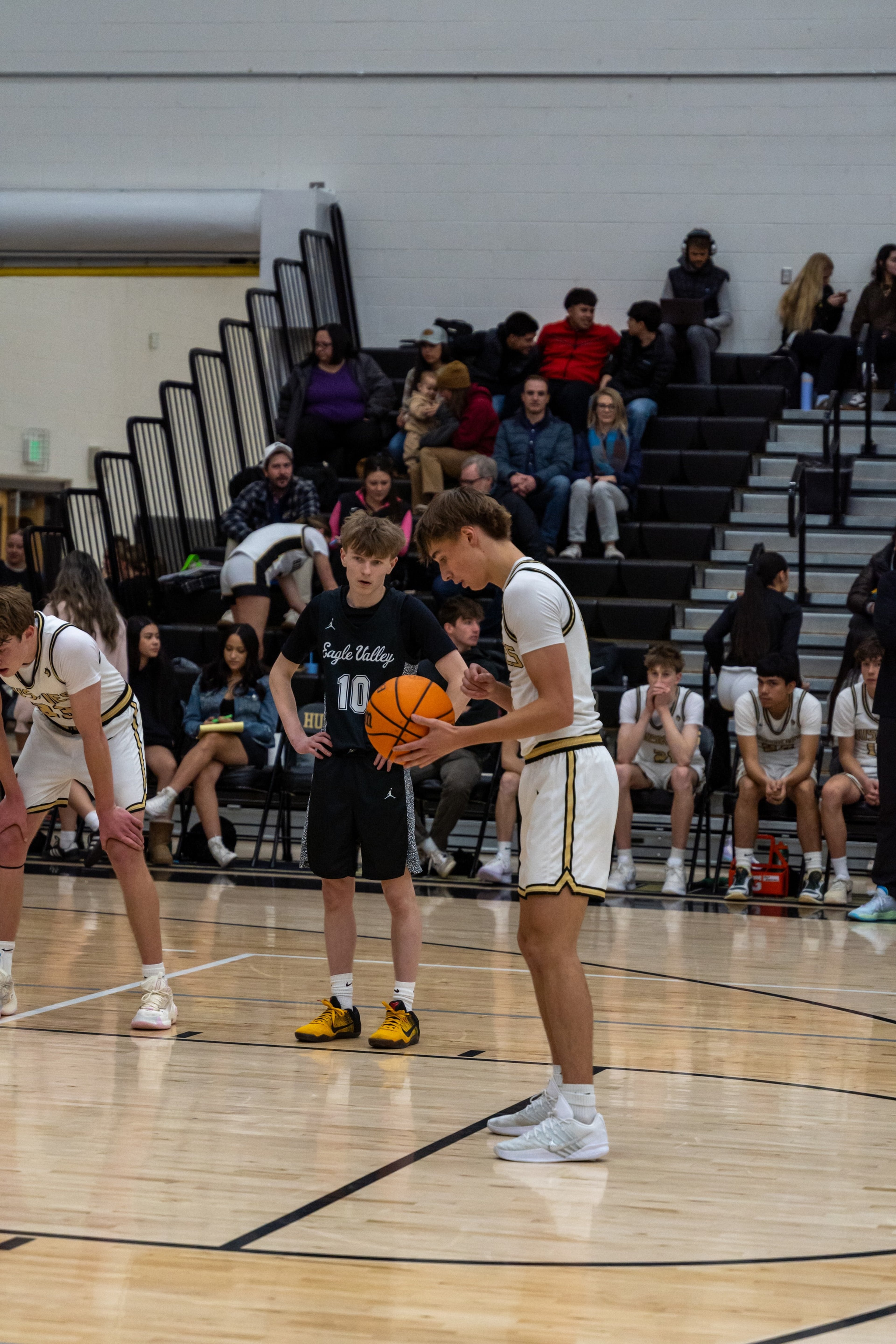 A player prepares at the free-throw line with the crowd behind him