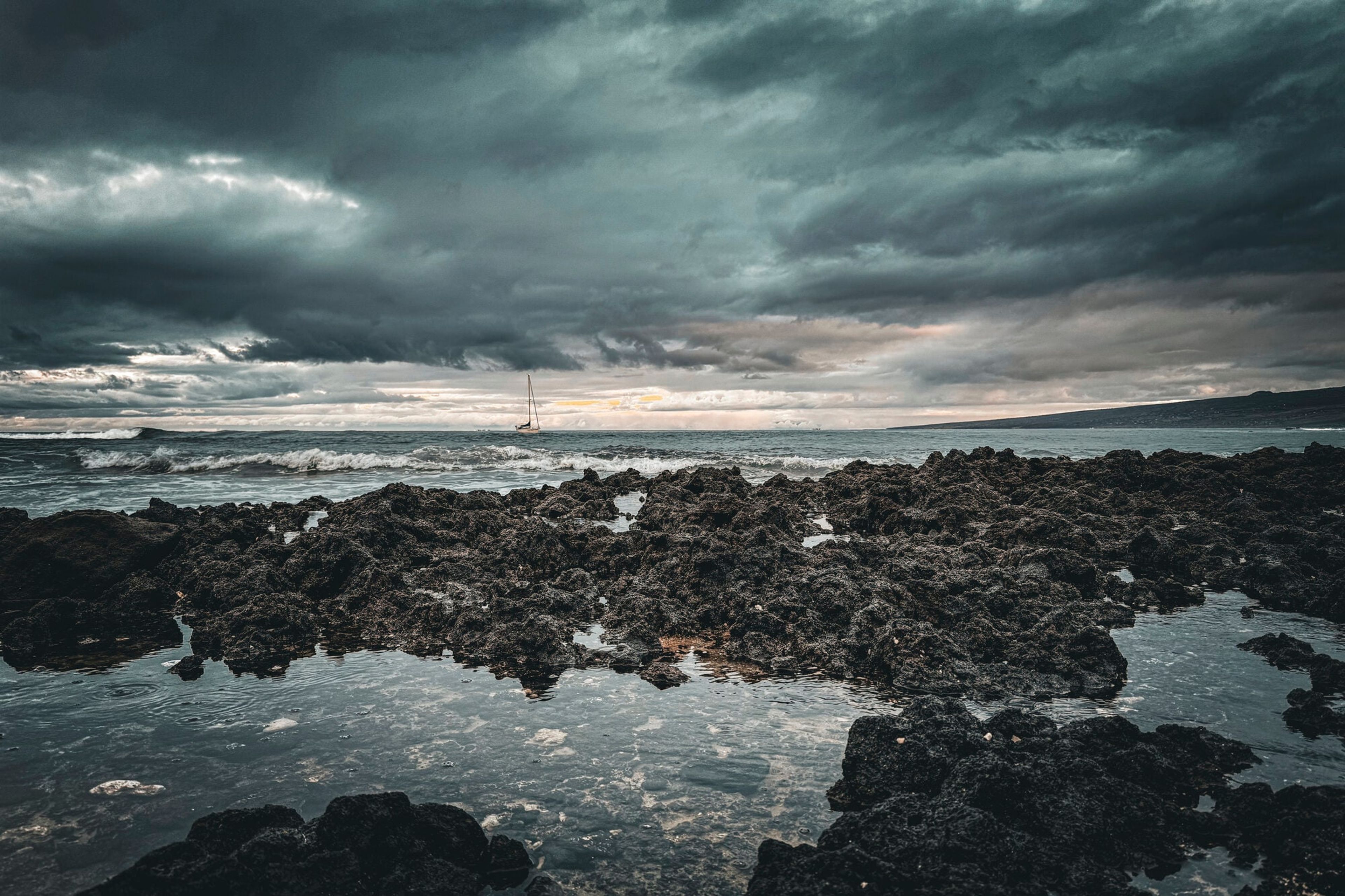 Storm light over dark lava tidepools on the Hawaiian coast