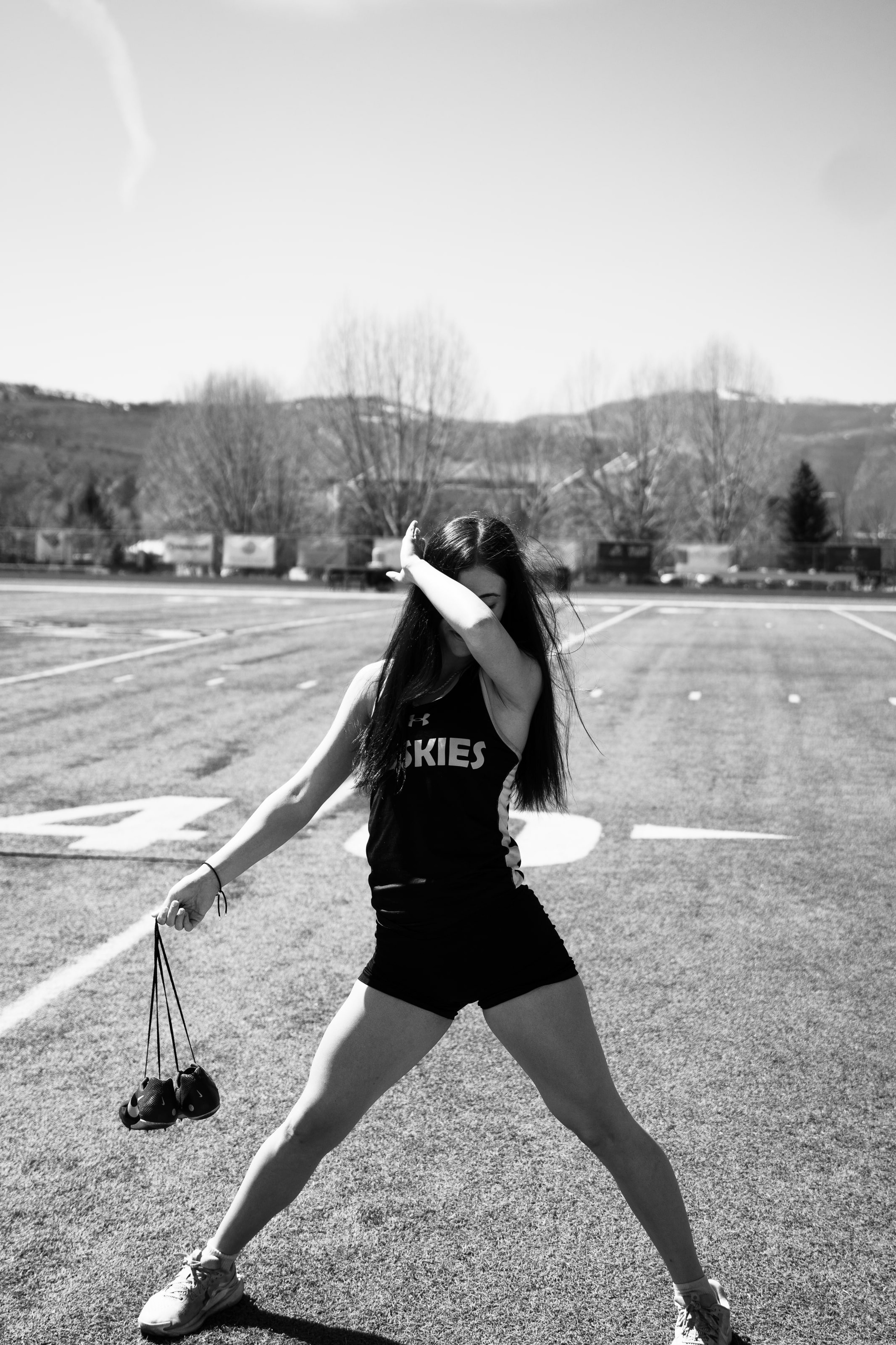Lucy winding up a discus throw, in black and white