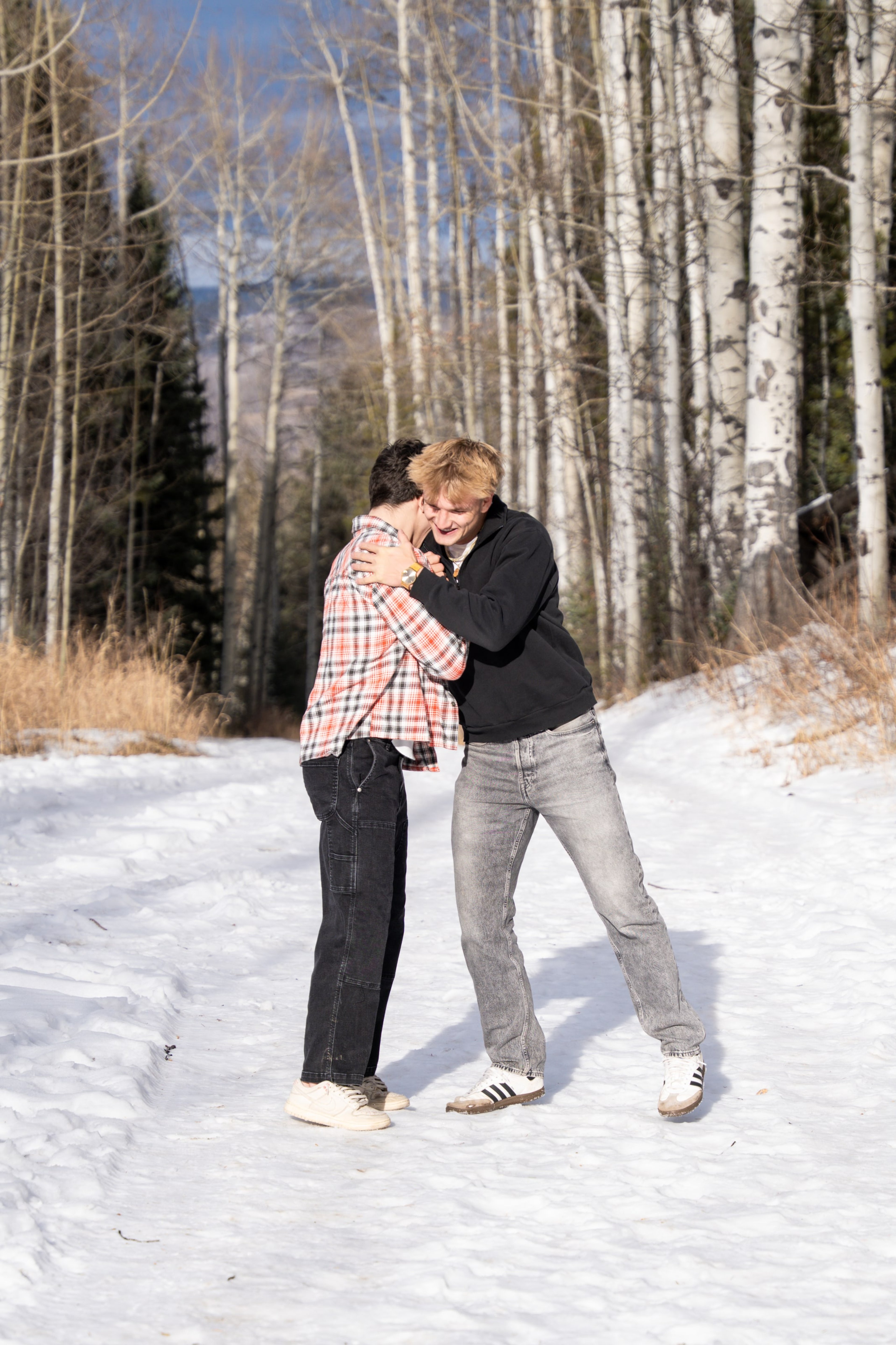 Jakob and Ryder cracking up together in the snowy aspens