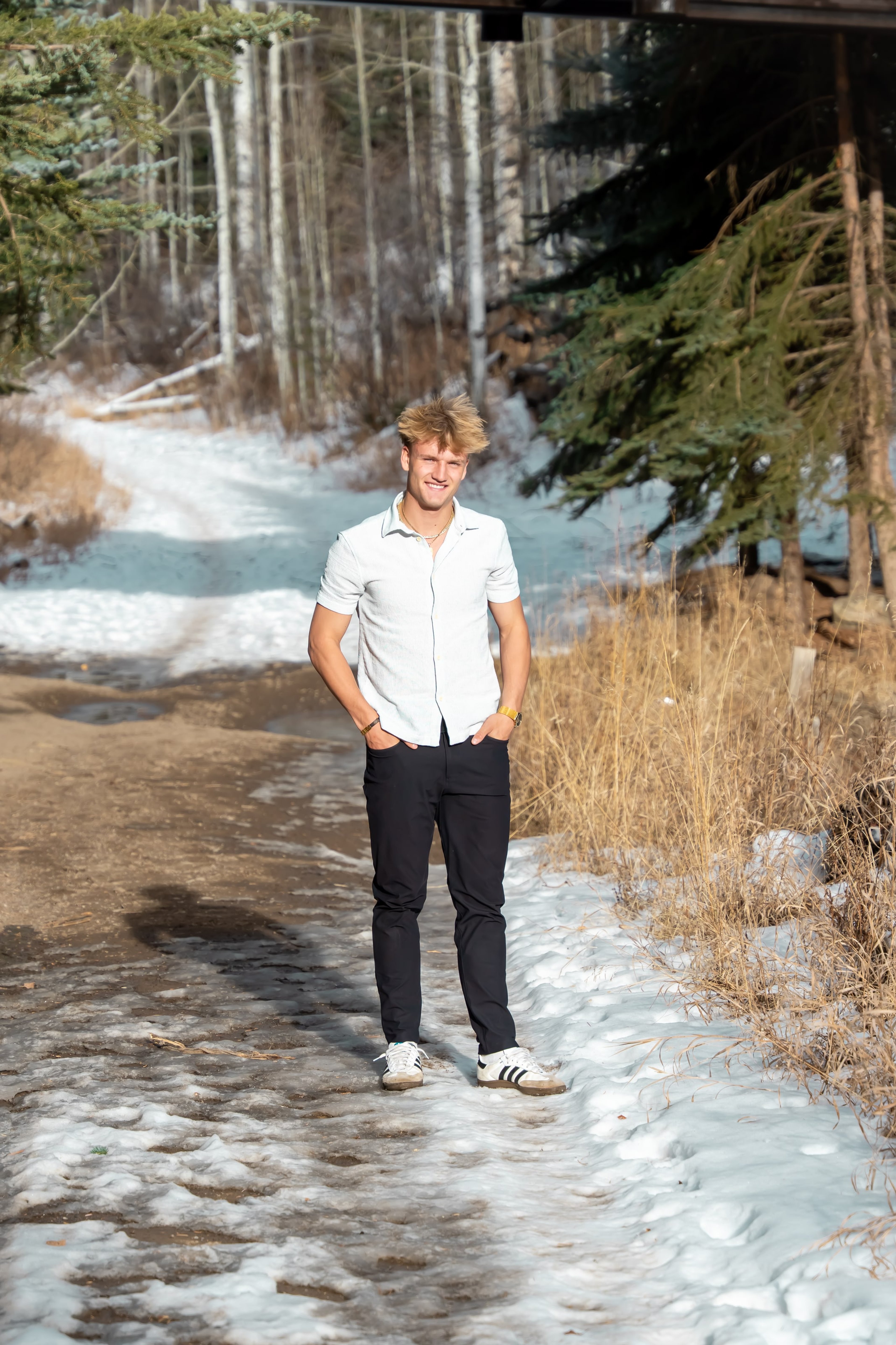 Jakob walking the creek path in a white shirt