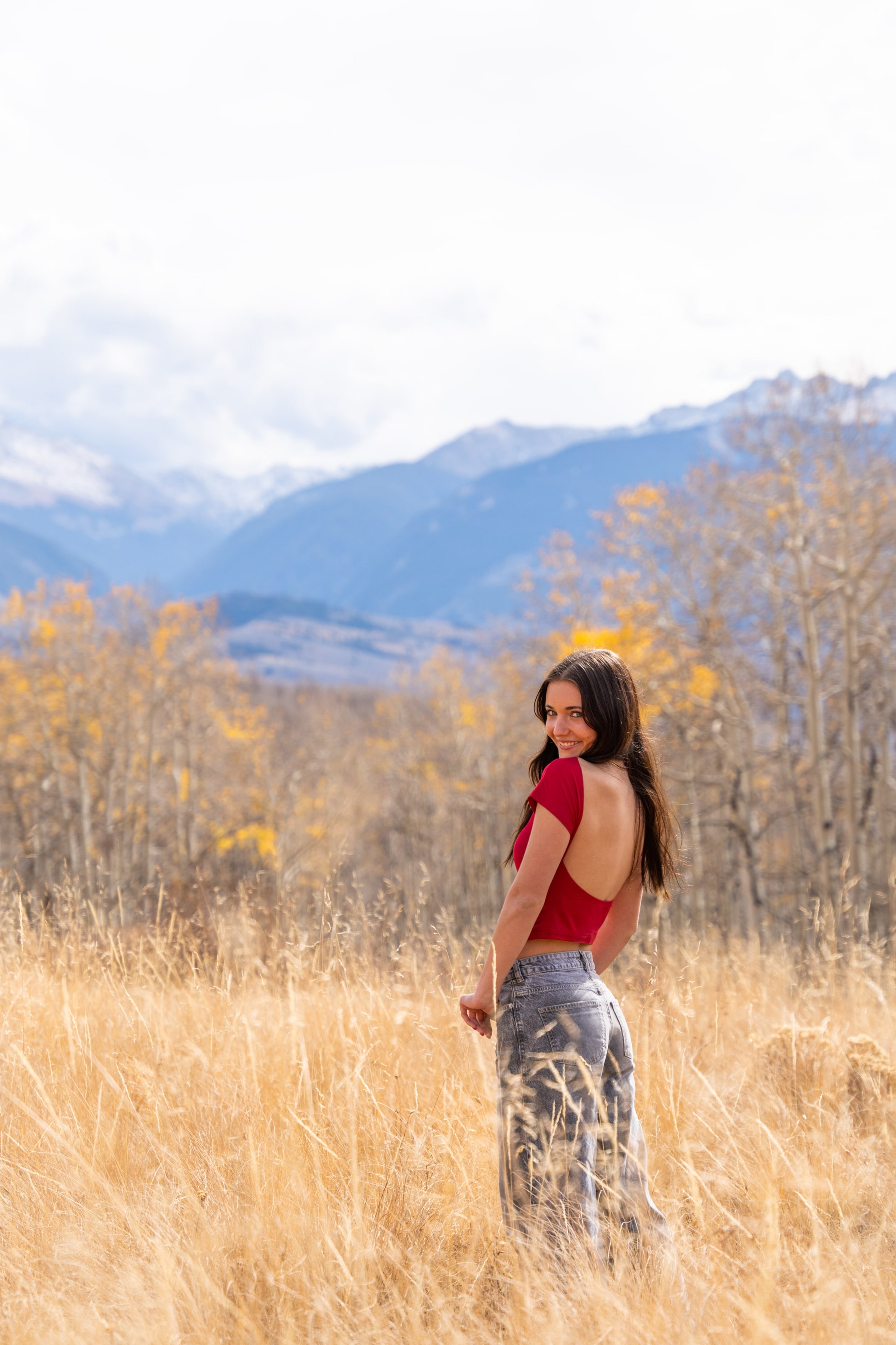Lucy glancing over her shoulder in a gold autumn field