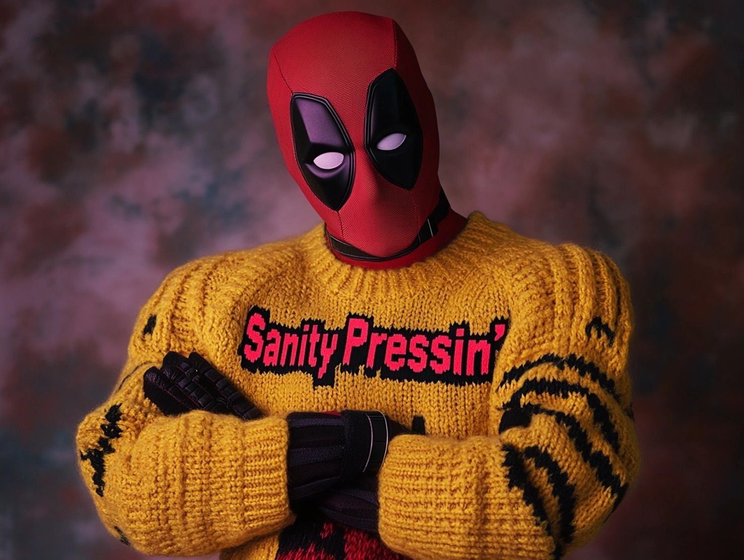 Deadpool wearing an ugly yellow Christmas sweater with the text "SanityPressin'", 80s awkward yearbook photo