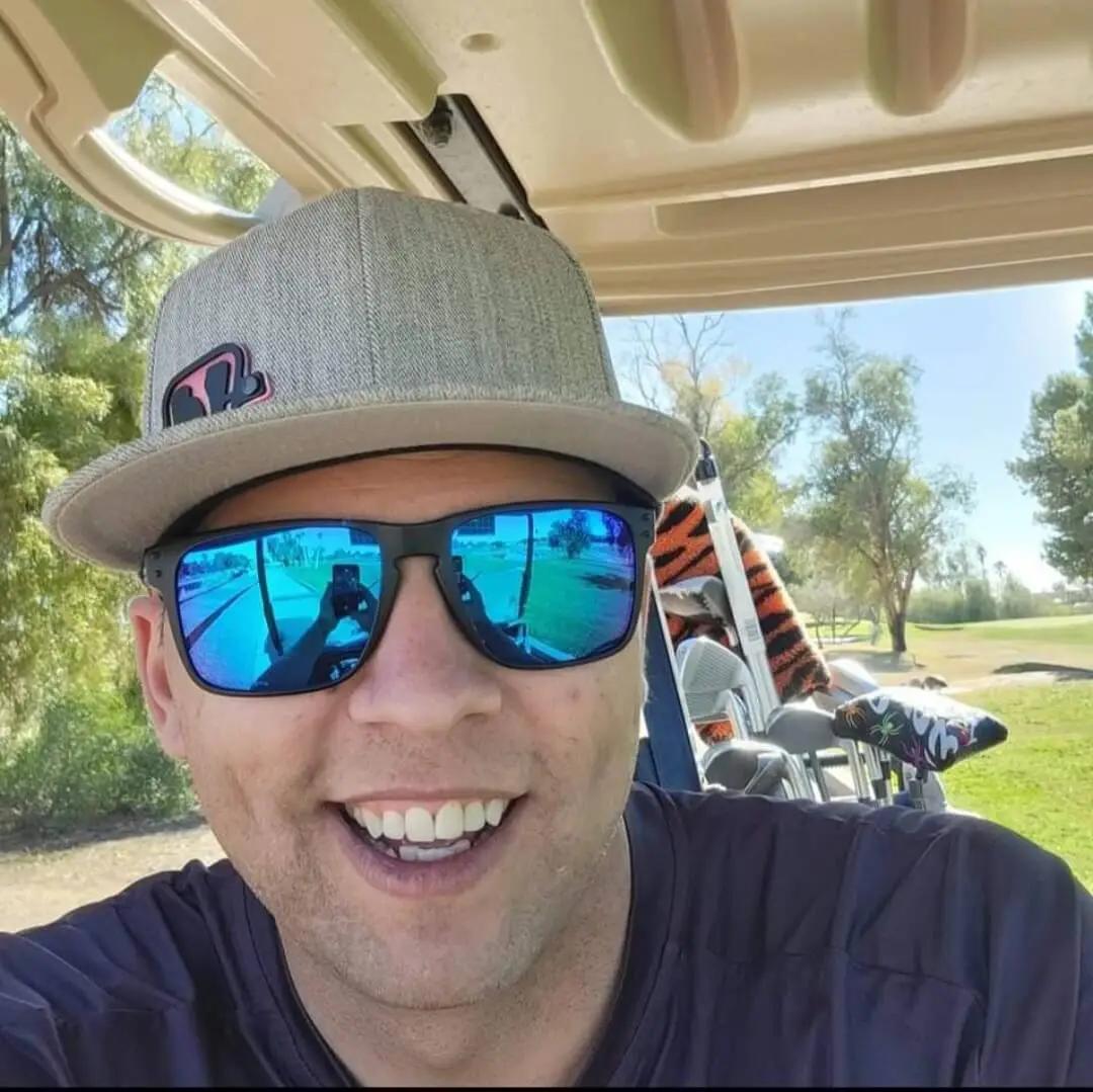 A picture of Kyle Conrad smiling in a golf cart.