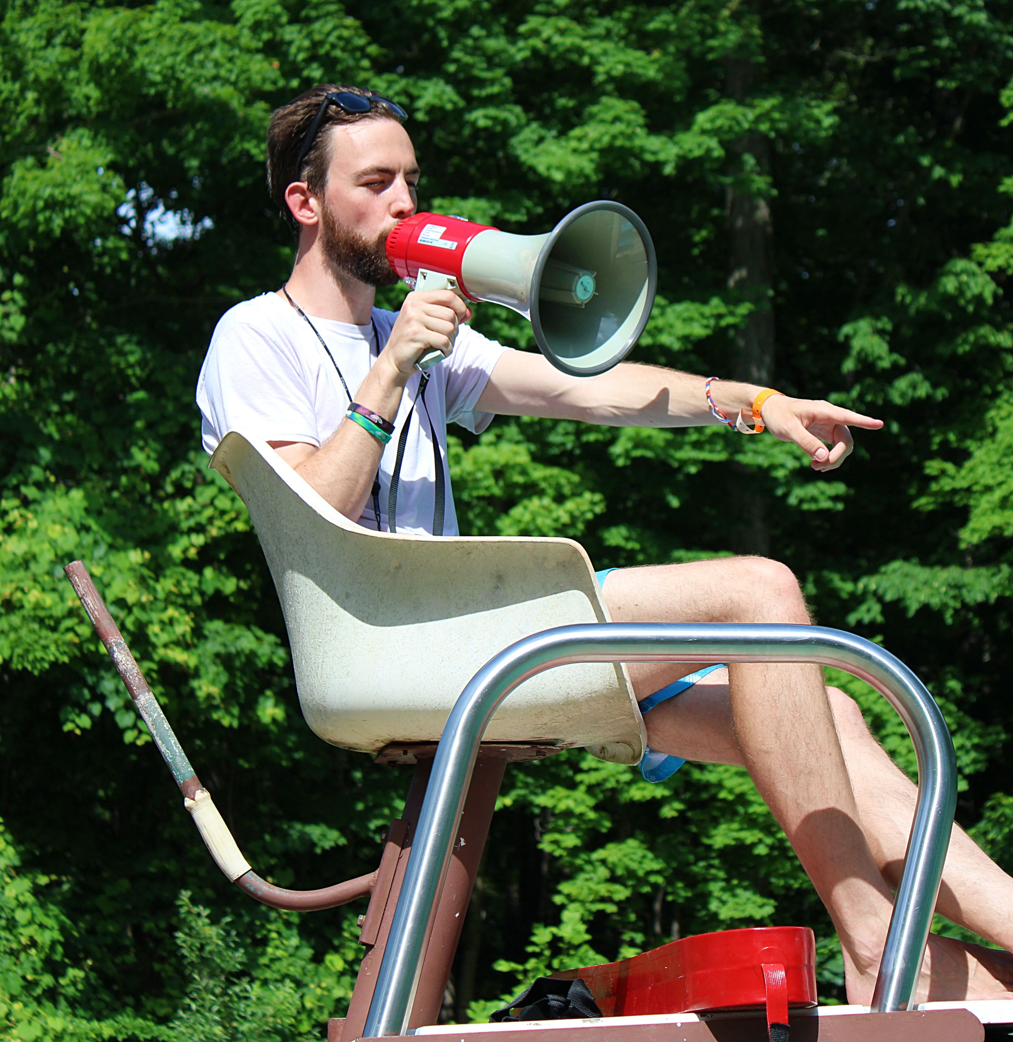 Lifeguard with loudspeaker on chair, at camp Laurelwood