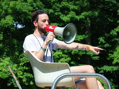 Lifeguard with loudspeaker on chair, at camp Laurelwood