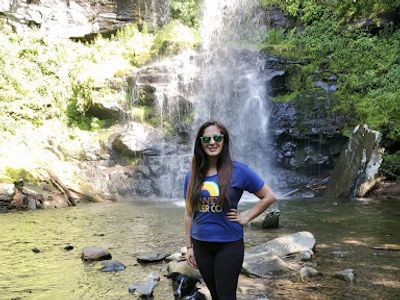 Photo of Cristina and her dog hiking