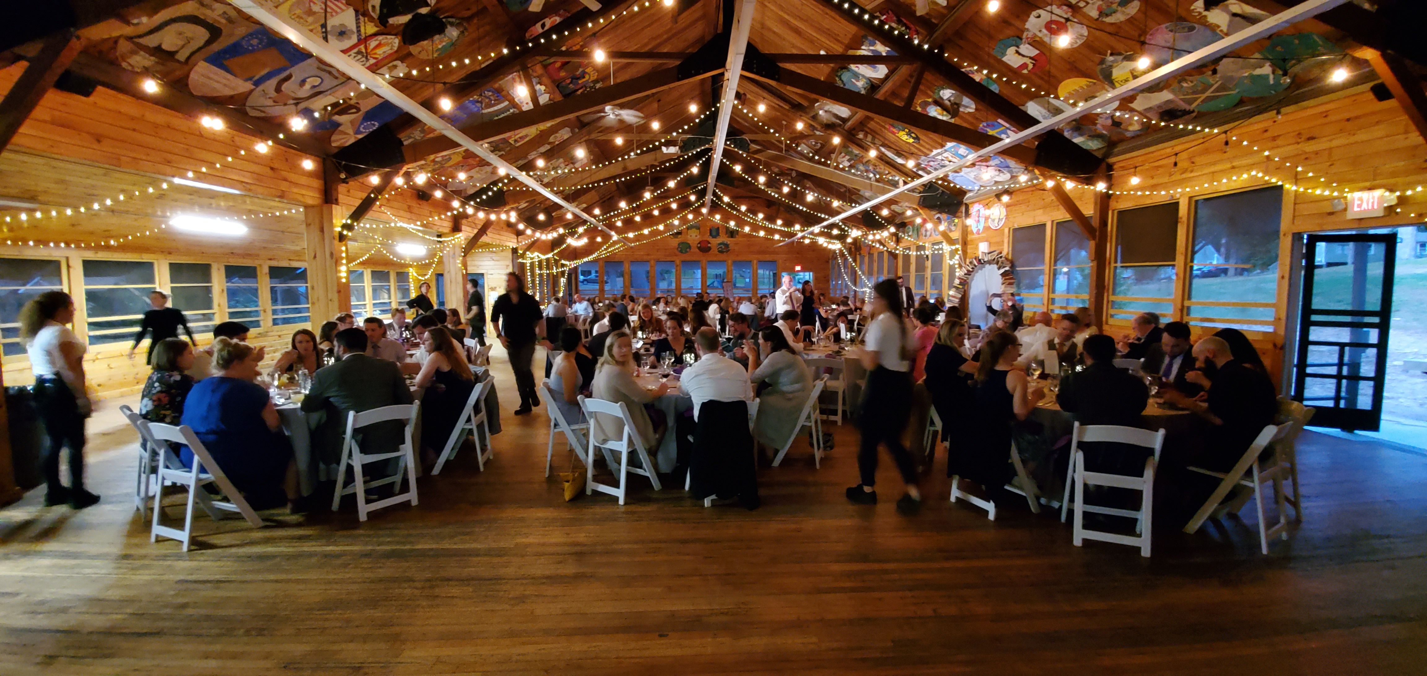People sitting down at tables during event at the Laurelwood Retreat Center