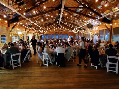 People sitting down at tables during event at the Laurelwood Retreat Center