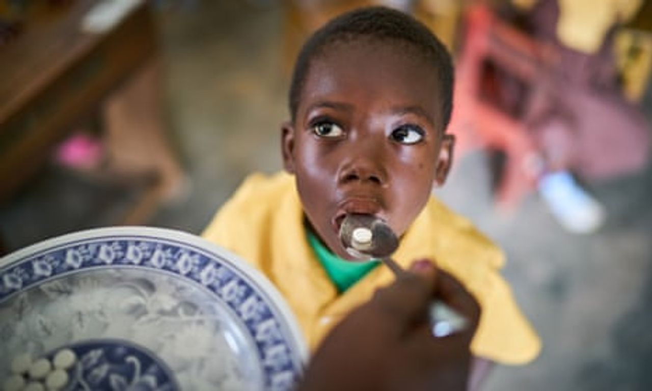 Florence Achiaa Amanfo, the SHEP (School Health Education Programme) coordinator gives medication to a pupil