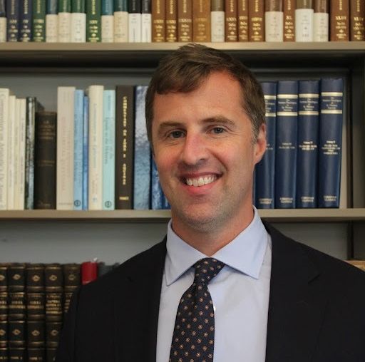 headshot of Speaker 1