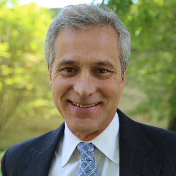 headshot of Speaker 1