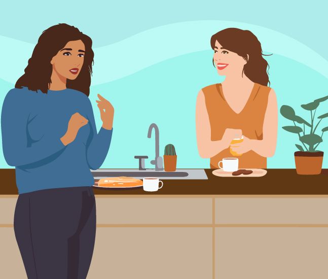 Two females chatting in a kitchen