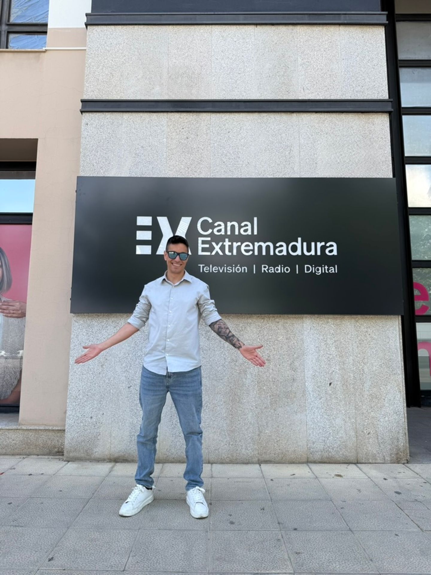 Juanjo Espada delante del nuevo rótulo de Canal Extremadura en la fachada de la sede
