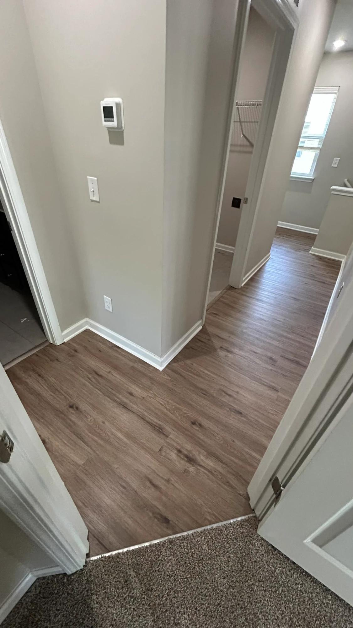Charlotte, NC · Warm Oak LVP · Clean undercuts at doorways