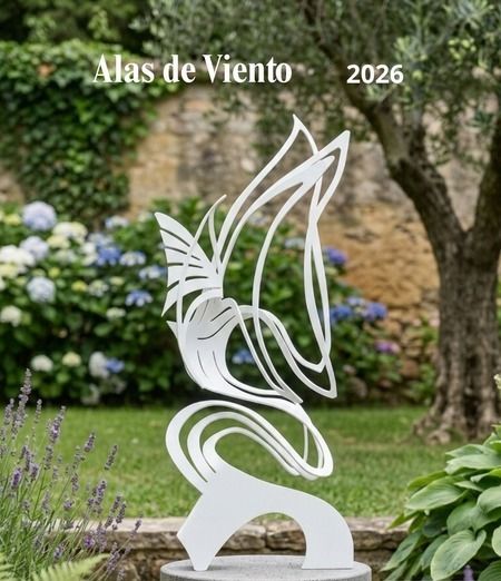 Alas de Viento, a black painted iron winged sculpture on a concrete pedestal in a Mediterranean courtyard garden