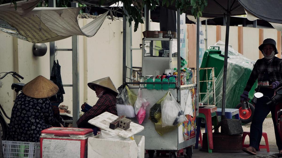 A local vendor at a small market stall in an underrated city
