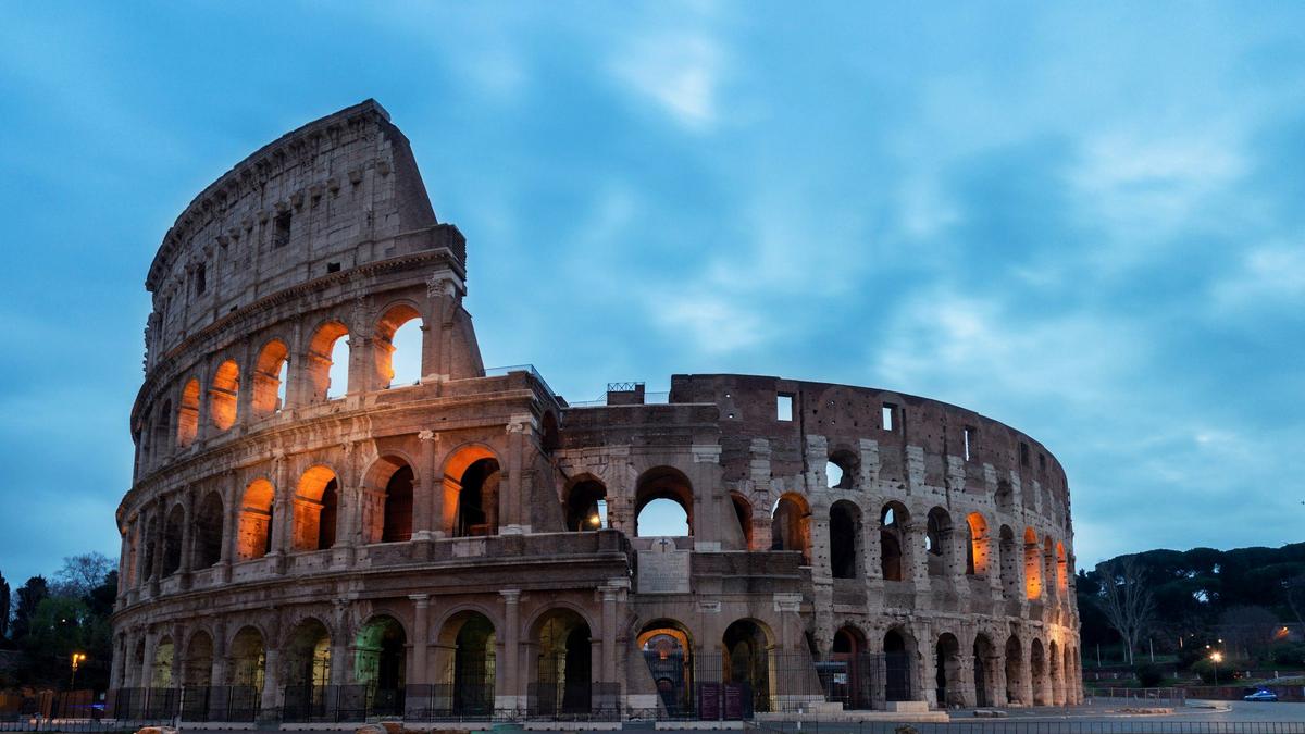 The Colosseum and Roman Forum ruins glowing at sunset in Rome