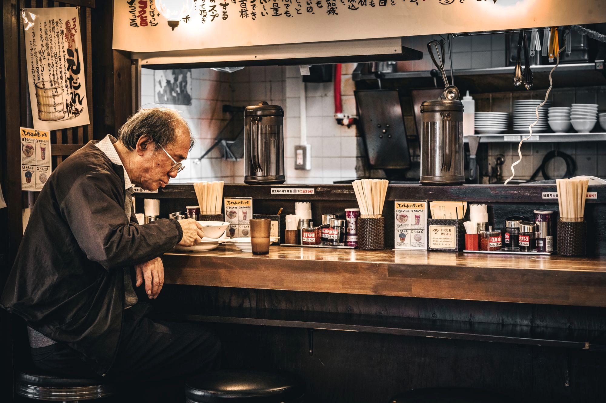 A steaming bowl of tonkotsu ramen at a small counter shop in Tokyo