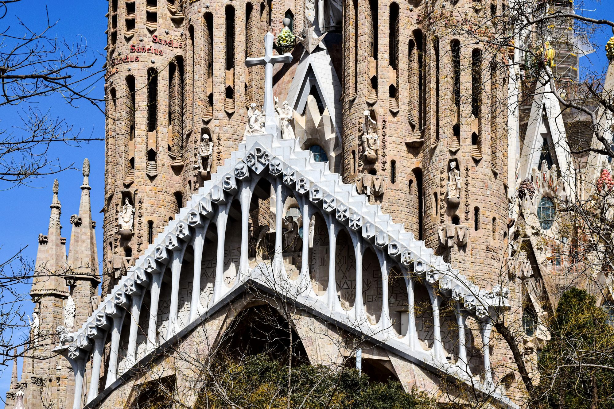 The intricate spires of the Sagrada Família rising against a clear morning sky