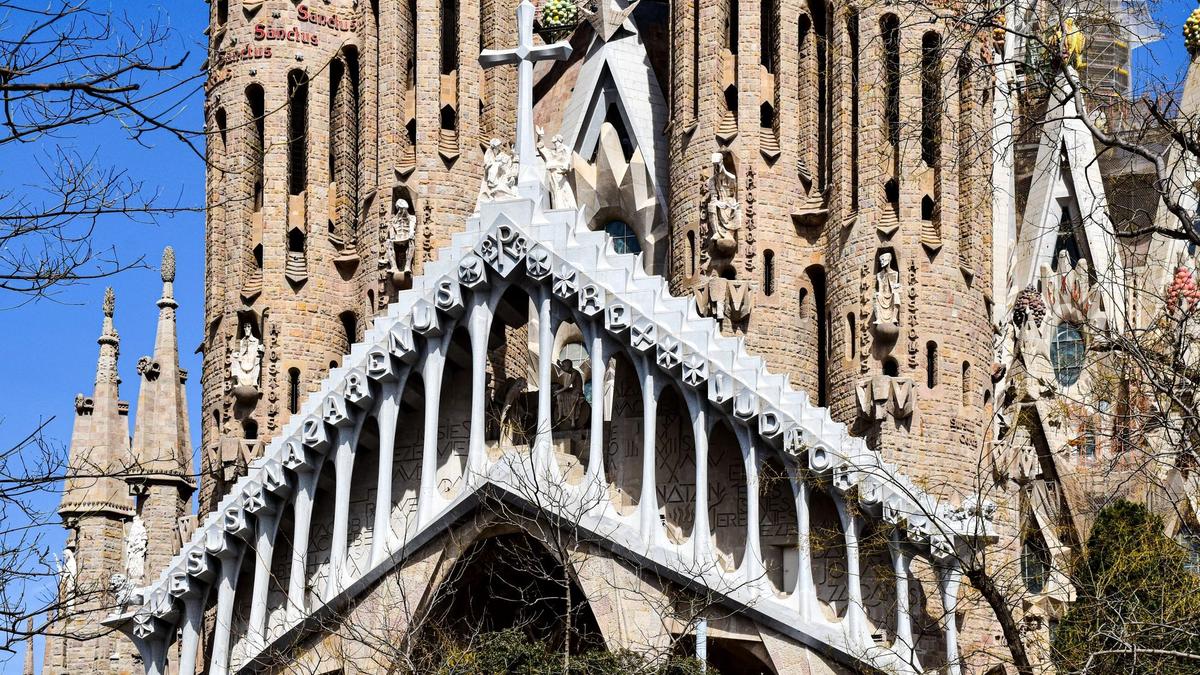 The intricate spires of the Sagrada Família rising against a clear morning sky