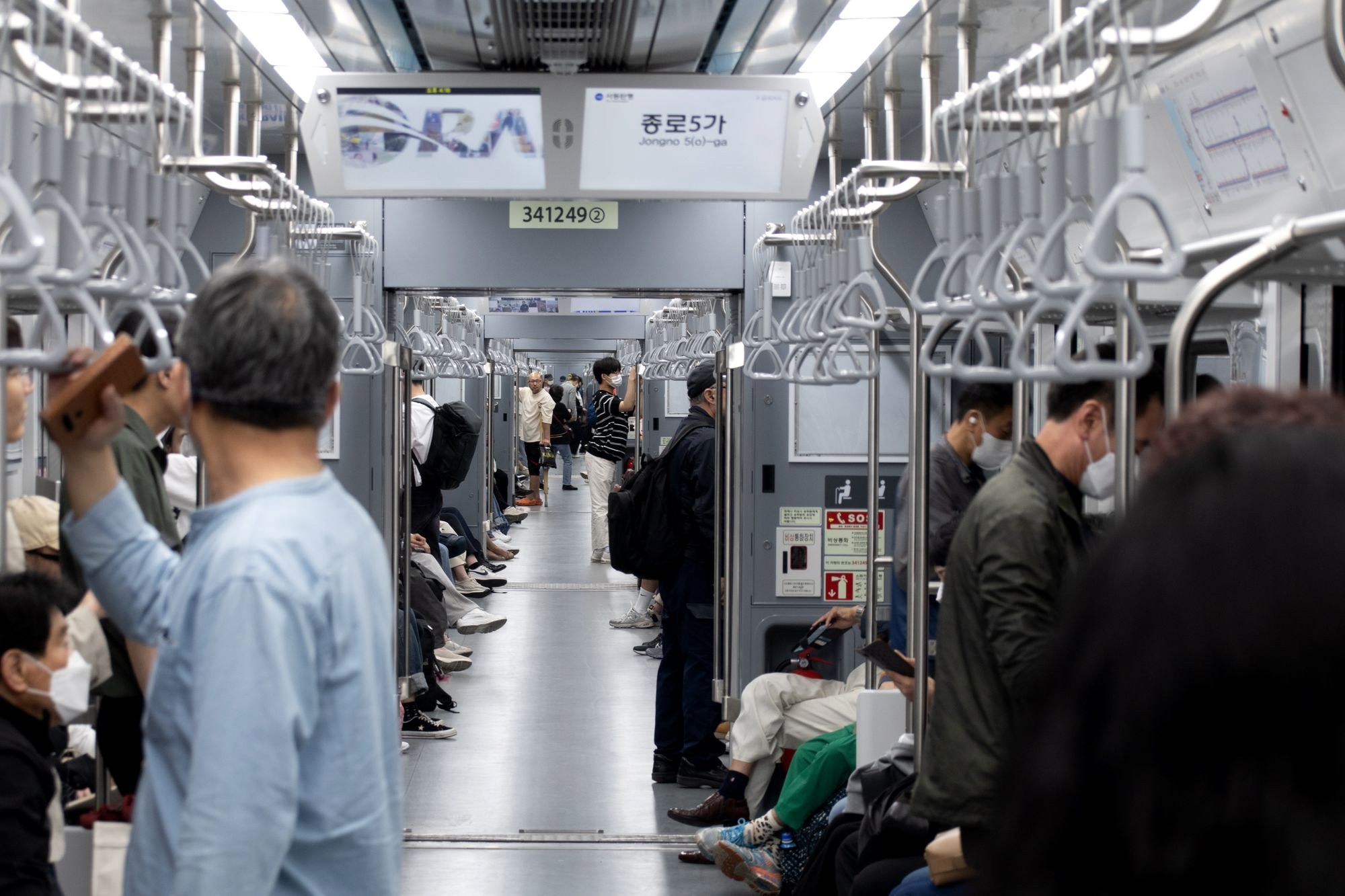 Passengers on a clean, modern Seoul subway platform