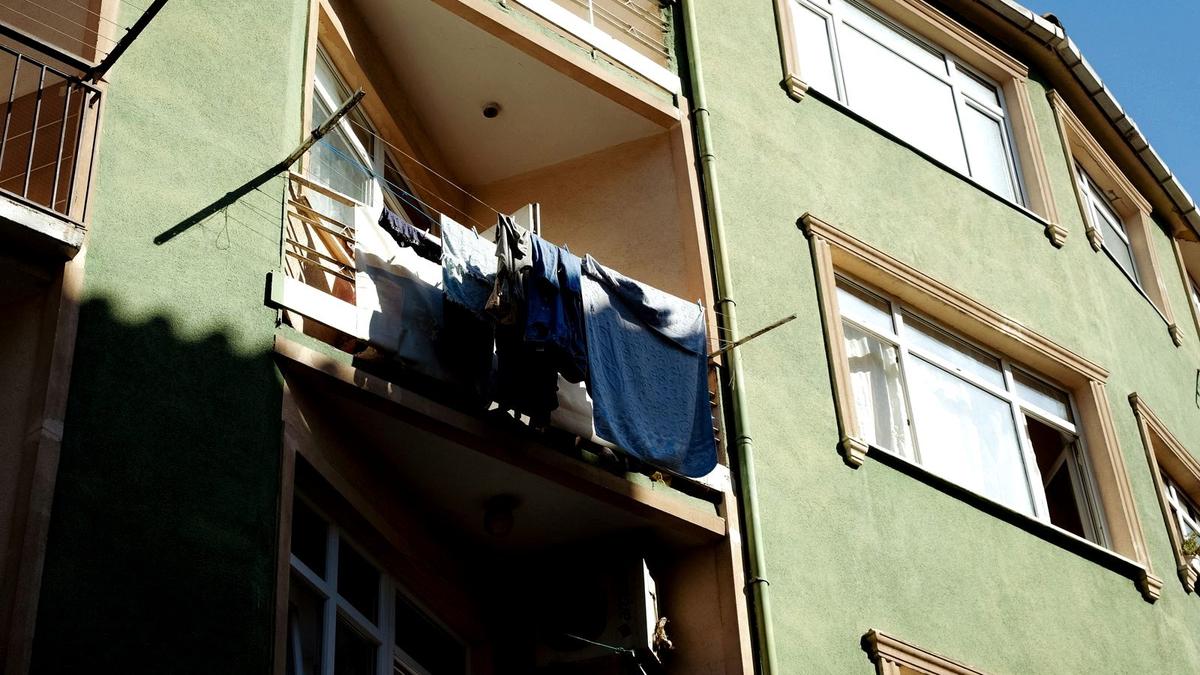 Freshly washed travel clothes hanging out to dry on a sunny balcony line