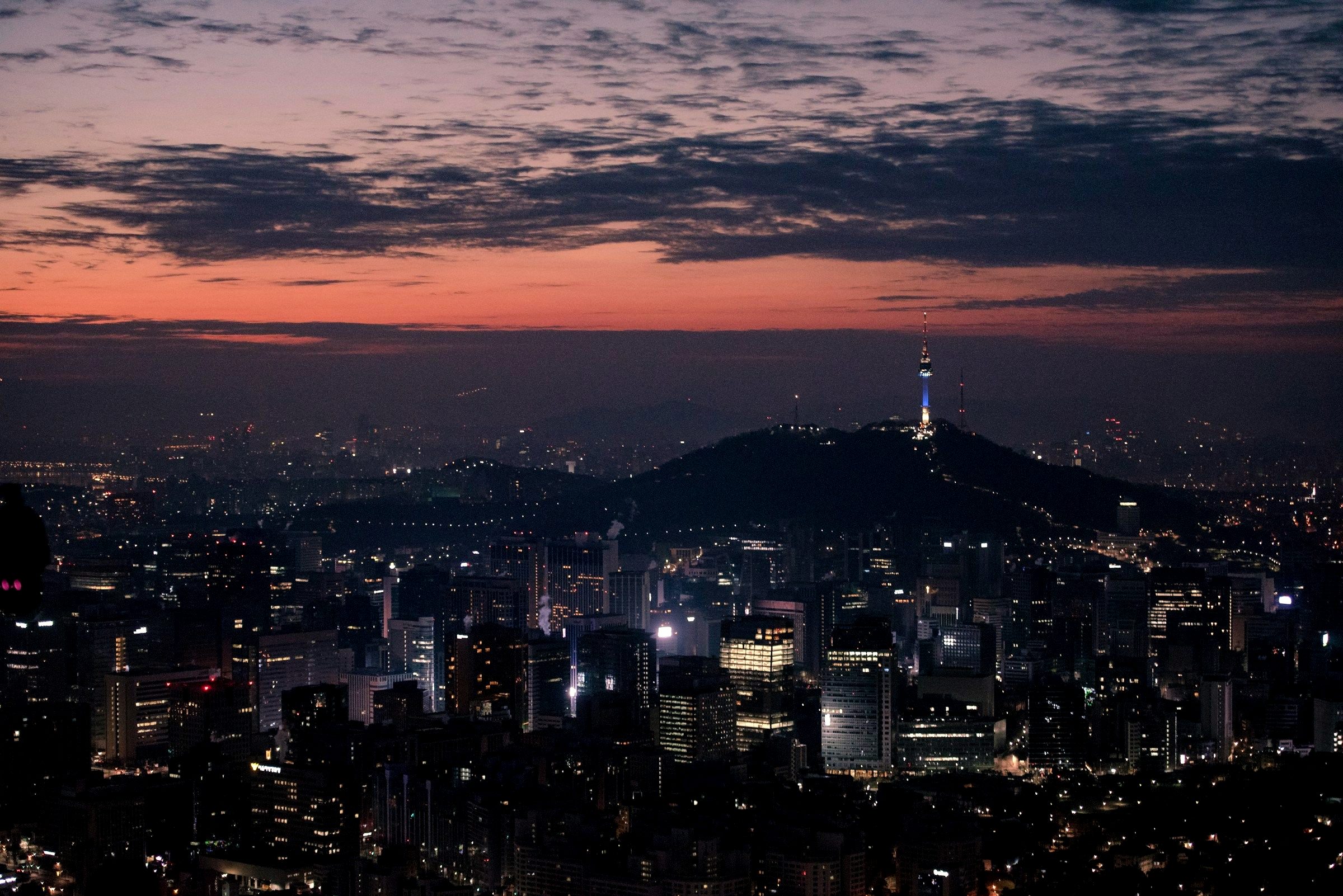 Seoul city skyline at night with N Seoul Tower lit on the hill