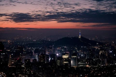 Seoul city skyline at night with N Seoul Tower lit on the hill