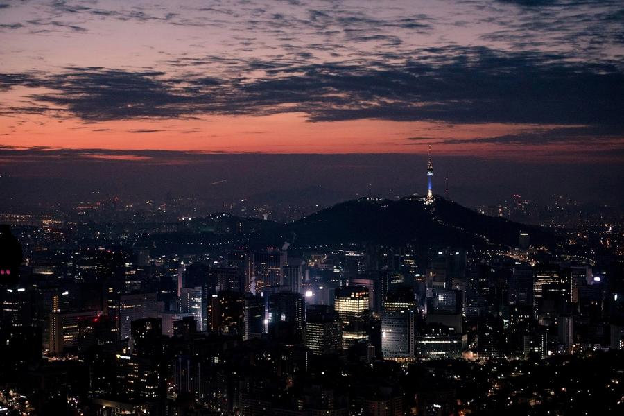 Seoul city skyline at night with N Seoul Tower lit on the hill