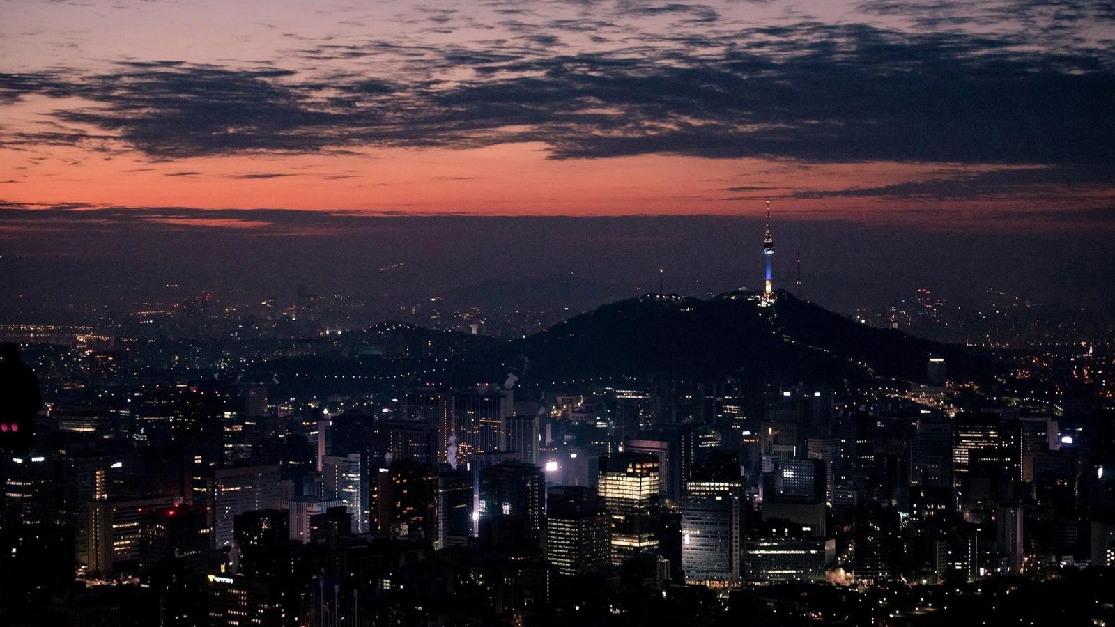 Seoul city skyline at night with N Seoul Tower lit on the hill
