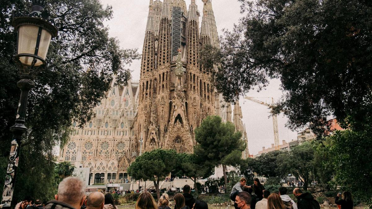 The intricate spires of the Sagrada Família rising against a clear morning sky