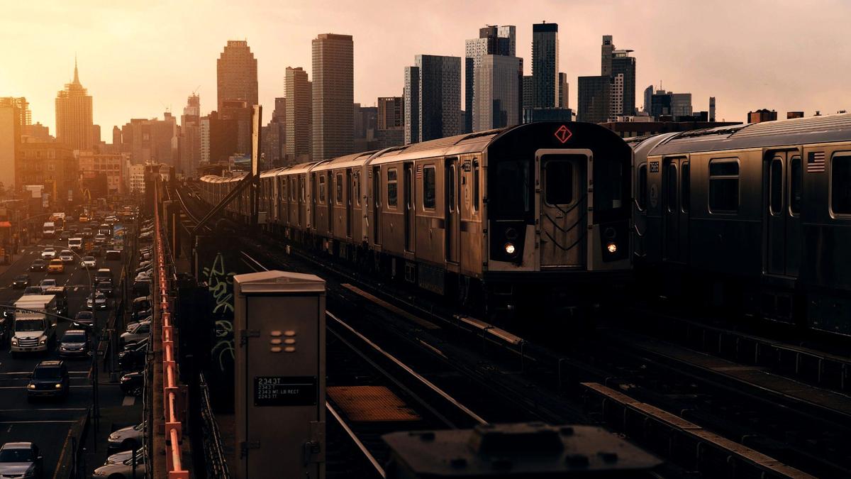 A New York City subway platform with an arriving train
