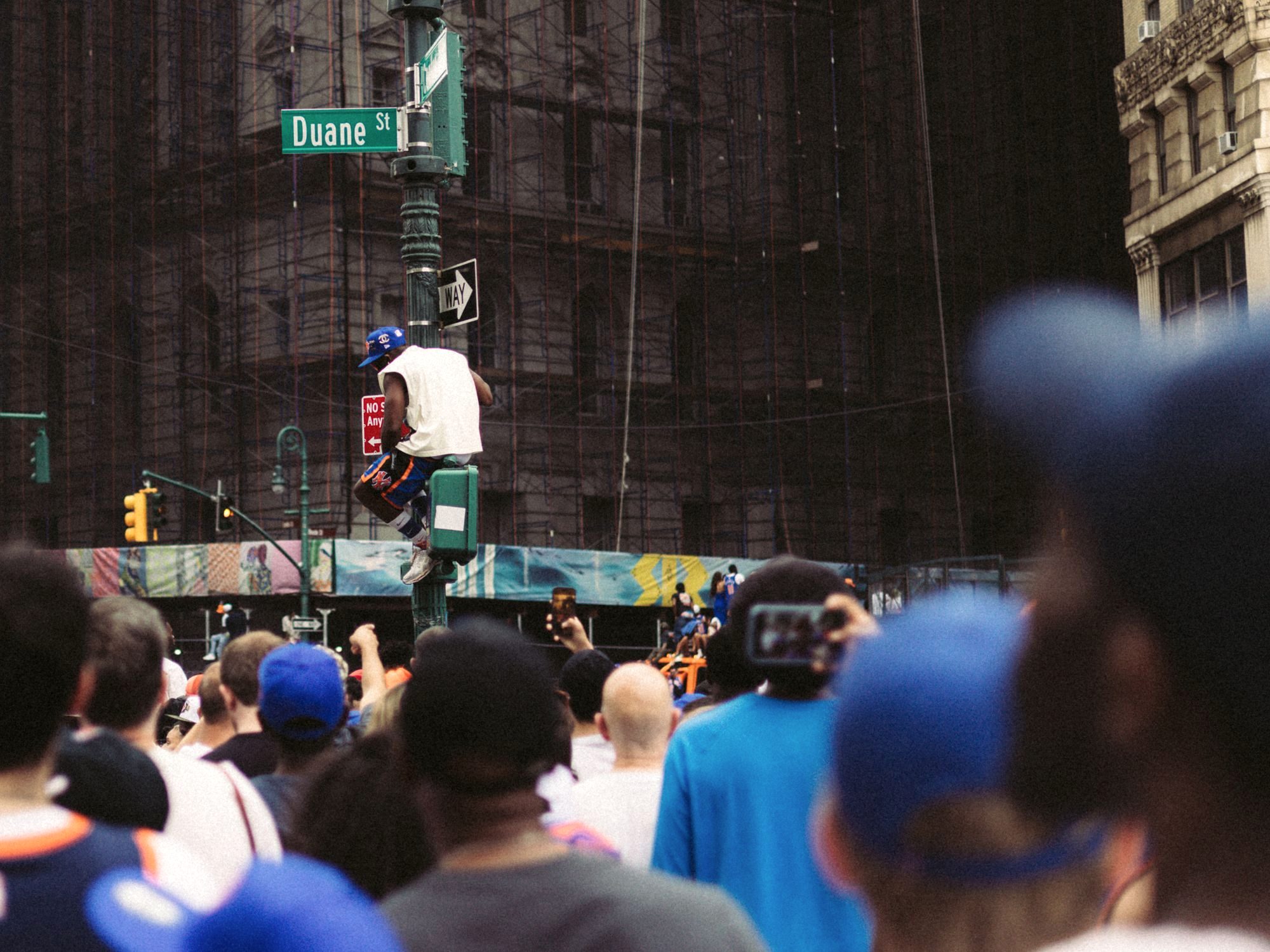 Crowds crossing a busy Manhattan avenue in New York City