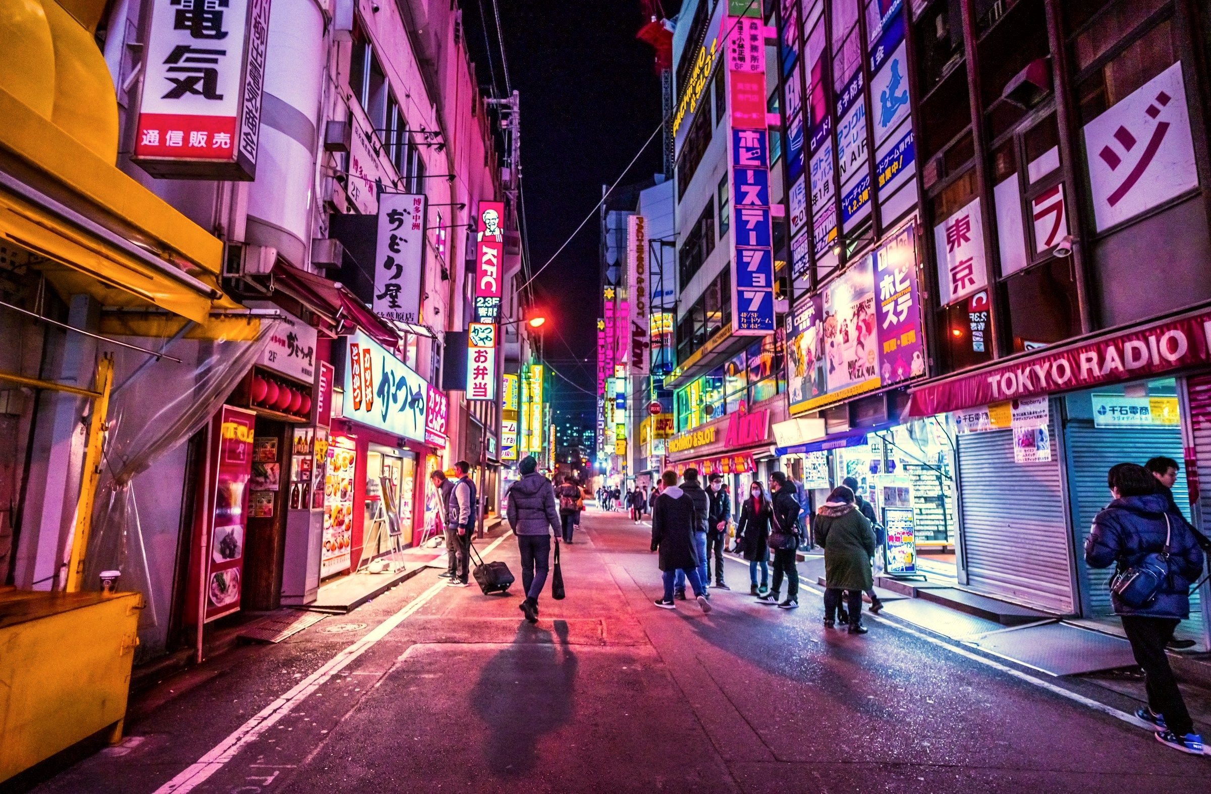 Neon signs and crowded pedestrian streets in Shinjuku at night